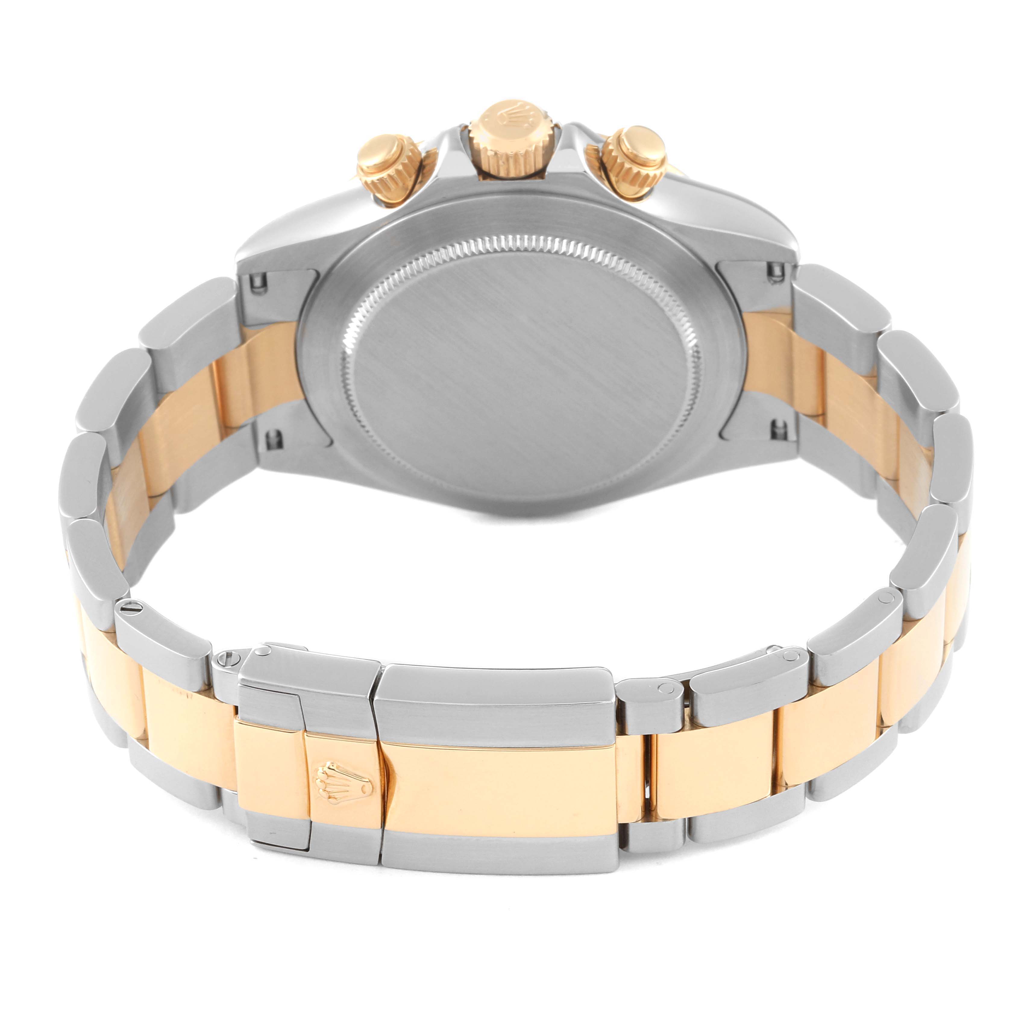 The image shows the backside and band of a Rolex Daytona 116523G Men
s Steel and Gold (two tone) White Dial 116523G Men
s Steel and Gold (two tone) White Dial watch from a rear angle.