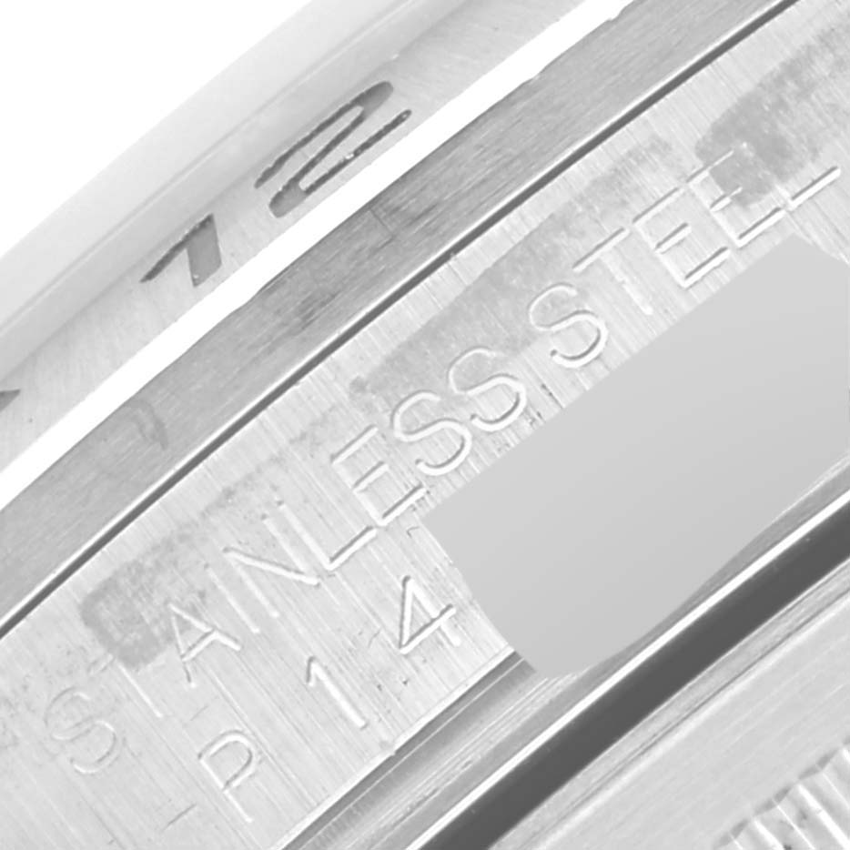 This is a close-up view showing the edge of the bezel and inner case of a Rolex Explorer 16570 Men's Stainless Steel White Dial 16570 Men's Stainless Steel White Dial watch, highlighting the "STAINLESS STEEL" engraving.