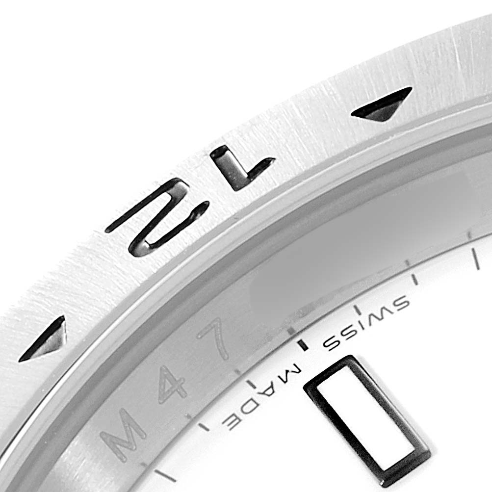 The image shows a close-up of the bezel and part of the dial of the Rolex Explorer 16570 Men's Stainless Steel White Dial 16570 Men's Stainless Steel White Dial watch, including the "Swiss Made" mark.