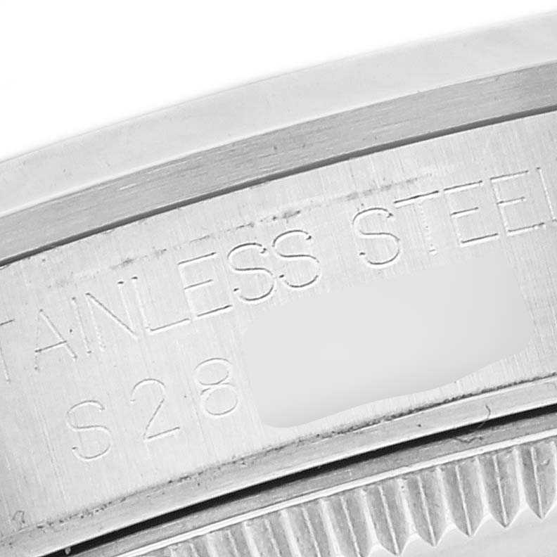 This is a close-up of the side of a Rolex Mid-Size 67480 Women
s Stainless Steel Pink Dial 67480 Women
s Stainless Steel Pink Dial watch, showing the stainless steel marking and part of the serial number.