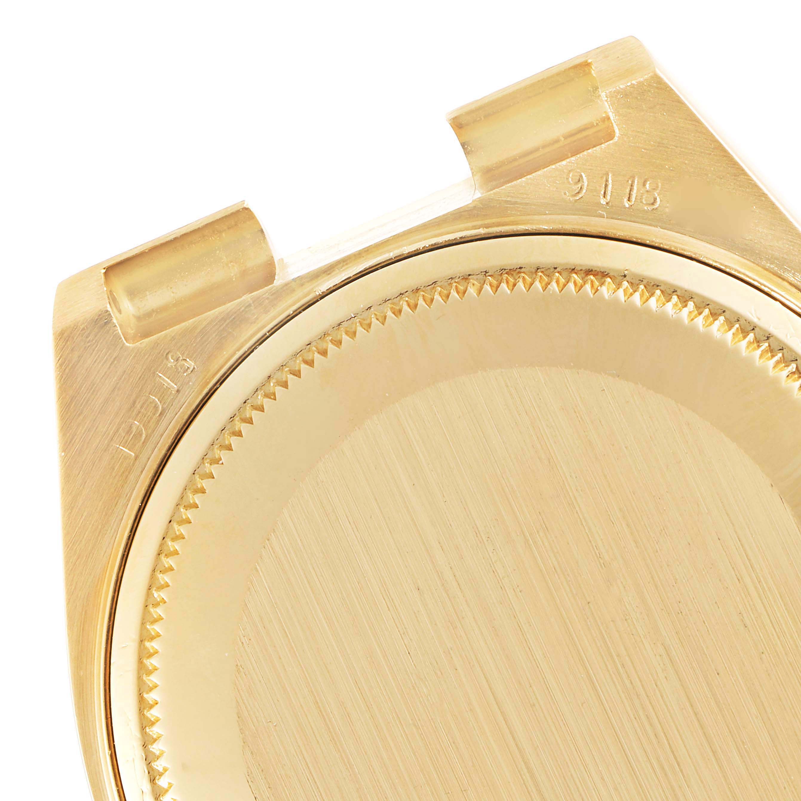 This image shows the case back and lugs of a Rolex Oysterquartz 19018 Men's Yellow Gold Champagne Dial 19018 Men's Yellow Gold Champagne Dial watch, focusing on its gold material and engravings.