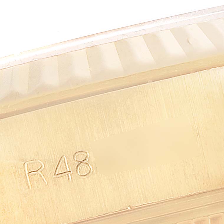 This close-up captures the fluted bezel and a portion of the engraved serial number of a Rolex President 69178 Women
s Yellow Gold Champagne Dial 69178 Women
s Yellow Gold Champagne Dial model watch.