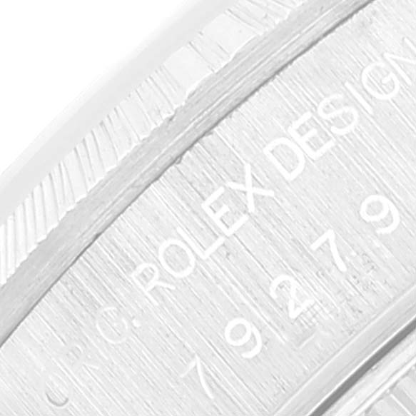 This image shows a close-up of the engraved bezel and the serial number area on a Rolex President 79279 Women's White Gold Pink Dial 79279 Women's White Gold Pink Dial model watch.