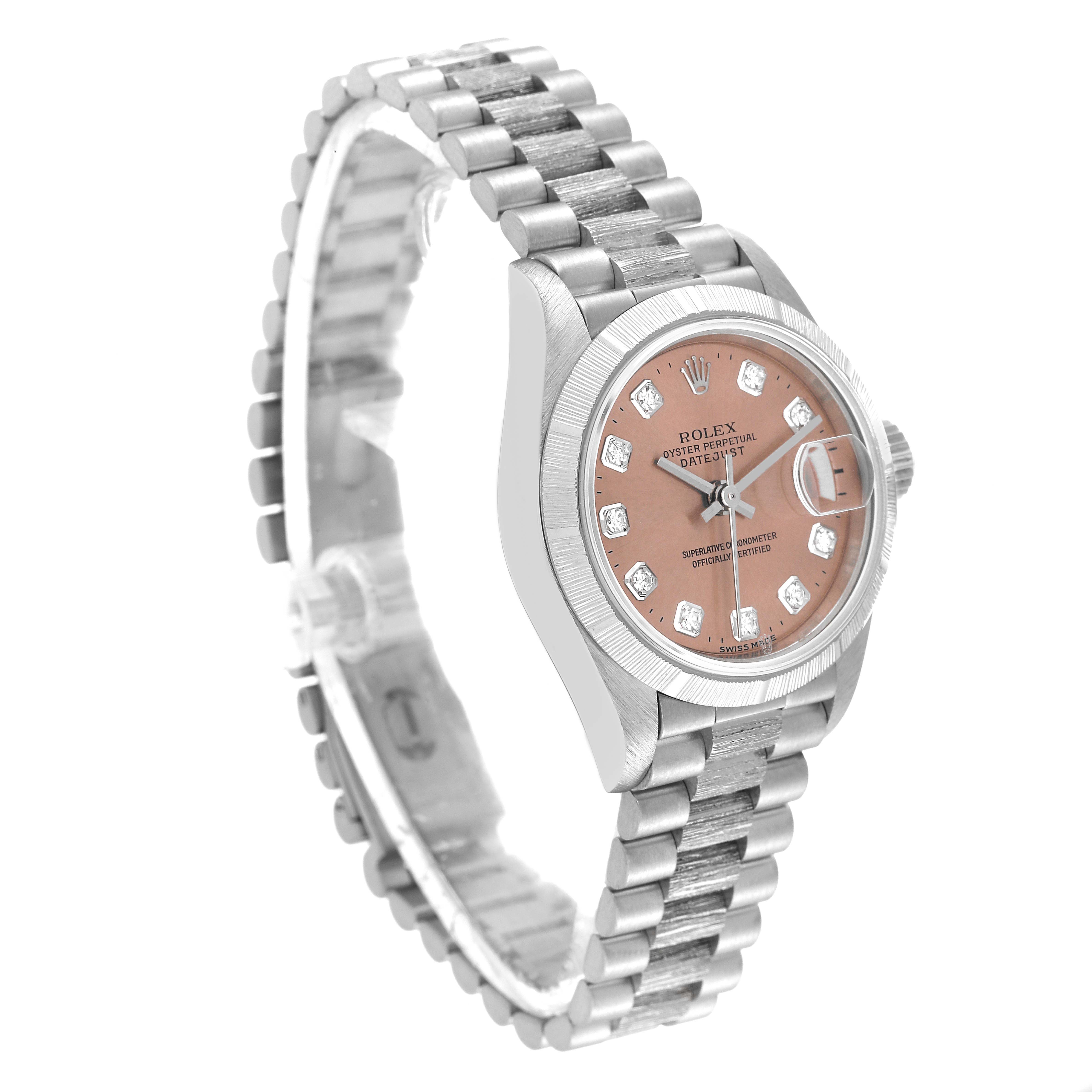 The image shows a side angle of the Rolex President 79279 Women's White Gold Pink Dial 79279 Women's White Gold Pink Dial watch, highlighting its band, bezel, and watch face with diamond accents.
