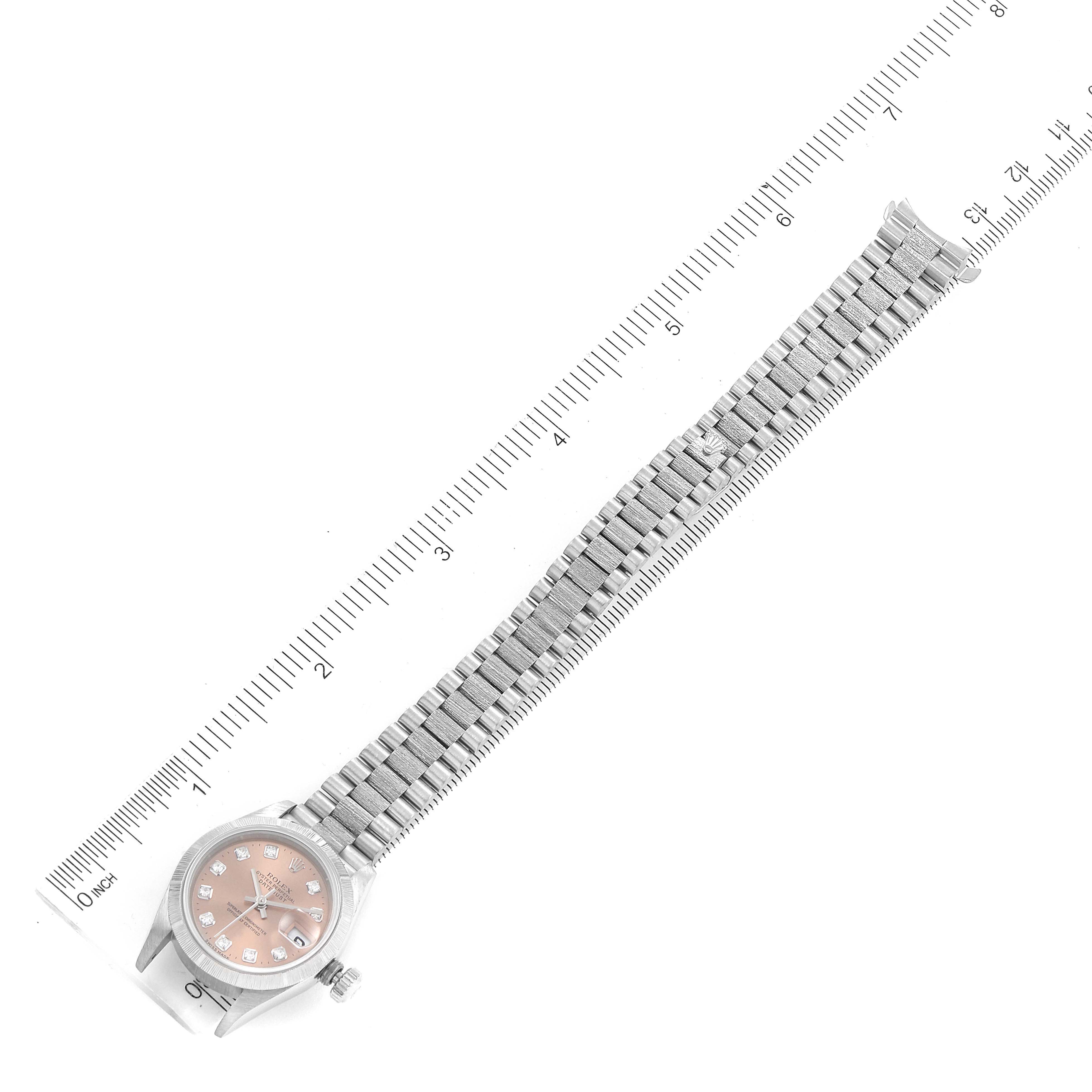The Rolex President 79279 Women's White Gold Pink Dial 79279 Women's White Gold Pink Dial model watch is shown from a top angle, displaying the full watch with a pink dial and a metal bracelet.