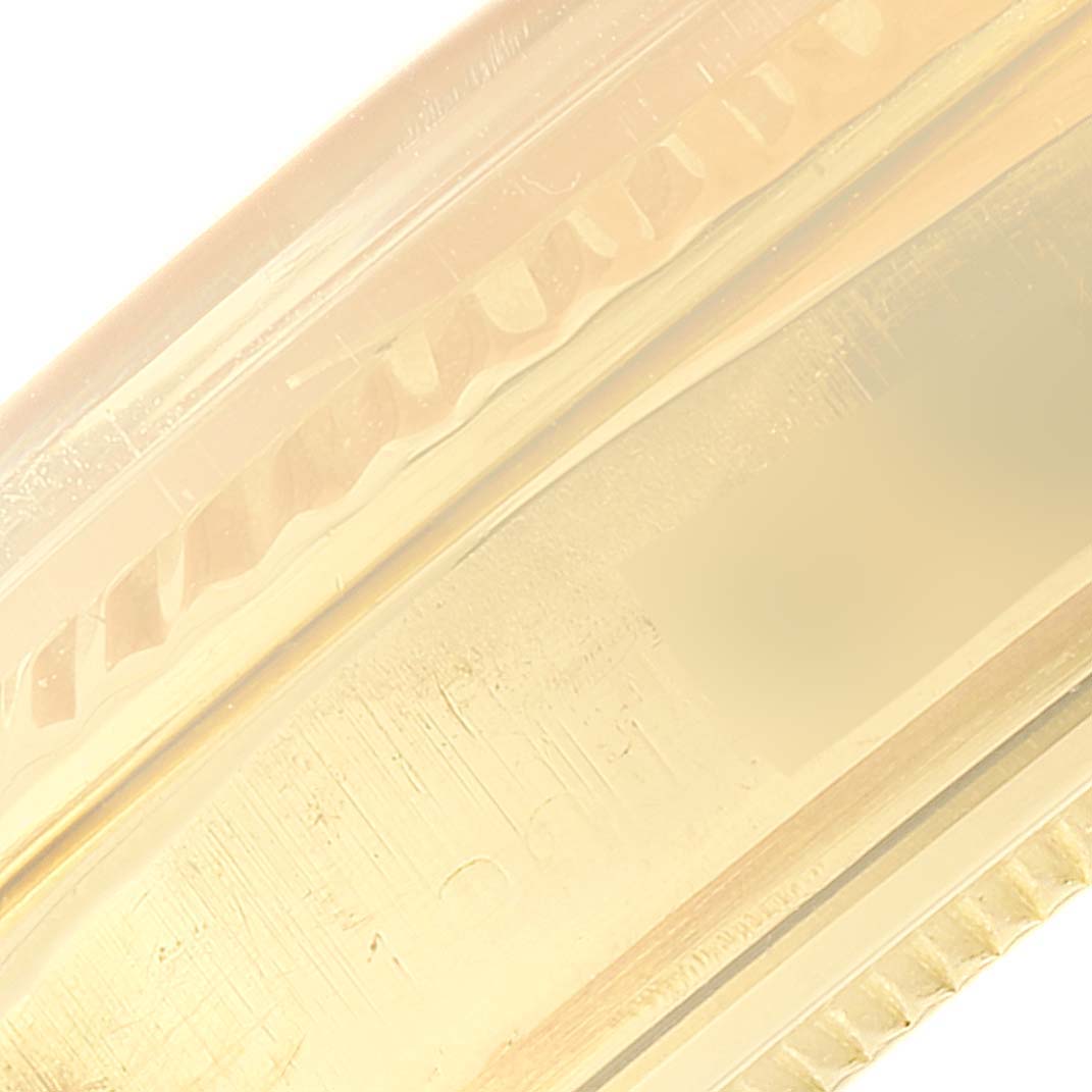 This is a close-up image, likely of the bezel or bracelet link, of a Rolex President 1803 Men's Yellow Gold Black Dial 1803 Men's Yellow Gold Black Dial model watch.