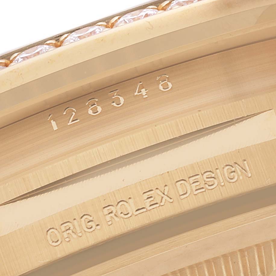 This close-up image shows the serial number and design engraving on the case of a Rolex President 128348RBR Men's Yellow Gold Green Dial 128348RBR Men's Yellow Gold Green Dial model watch.