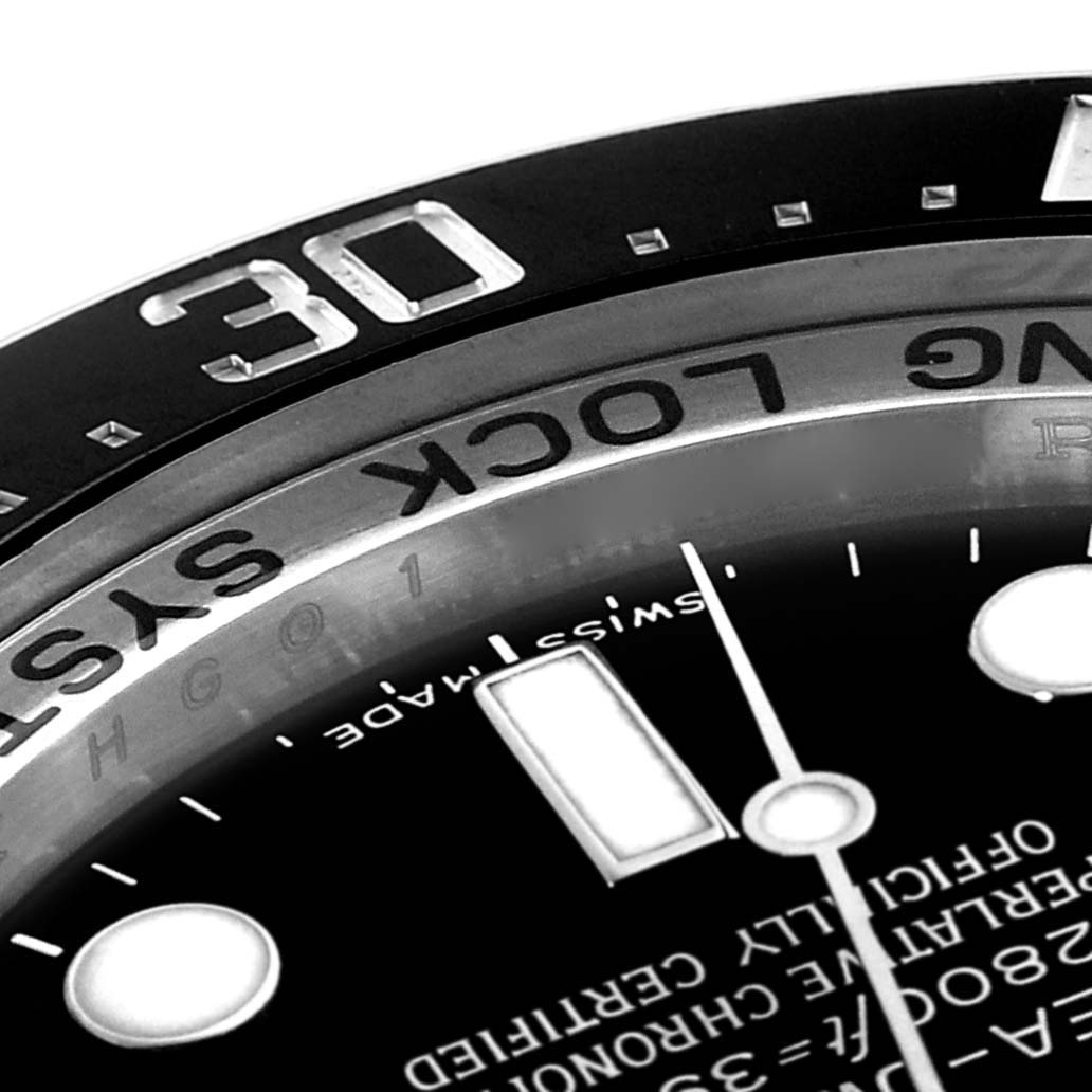 The image shows a close-up angle of the bezel, dial, and part of the face of a Rolex Sea-Dweller 116660 Men
s Stainless Steel Black Dial 116660 Men
s Stainless Steel Black Dial watch.