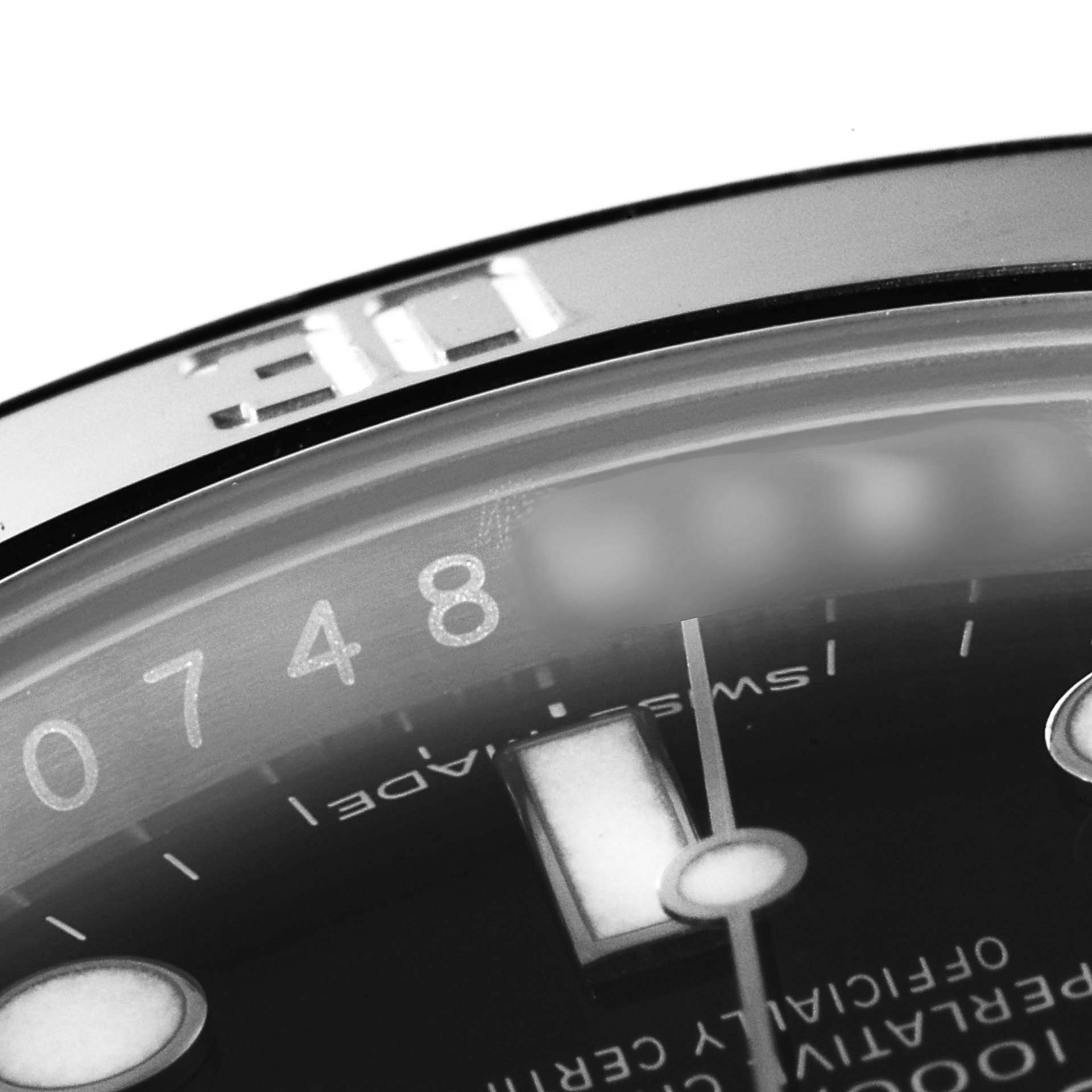 This image shows a close-up of the bezel and part of the dial of the Rolex Submariner 114060 Men
s Stainless Steel Black Dial 114060 Men
s Stainless Steel Black Dial watch, focusing on details such as the number markings.