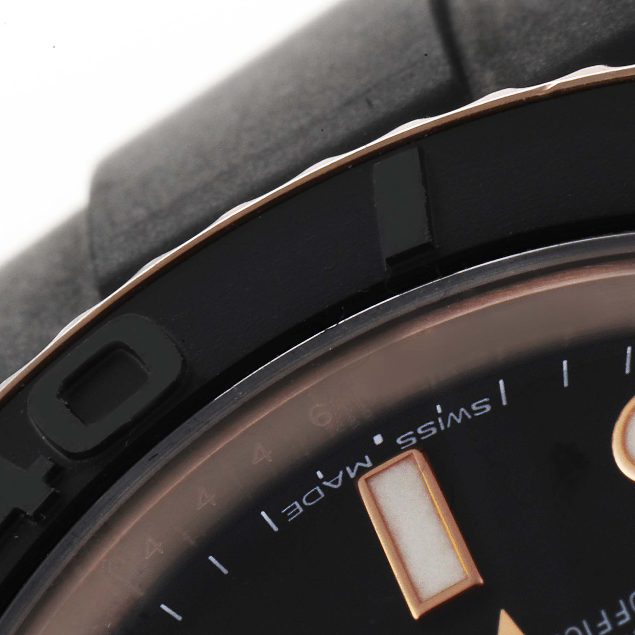 The close-up angle shows the bezel, part of the dial, and a portion of the strap of the Rolex Yacht-Master 268655 Men's Rose Gold Black Dial 268655 Men's Rose Gold Black Dial watch.