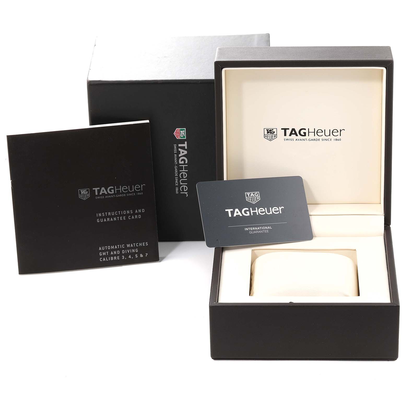 The image shows the packaging, instruction booklet, guarantee card, and watch box for a Tag Heuer Aquaracer WAJ2182 Men
s Titanium Black Dial WAJ2182 Men
s Titanium Black Dial watch.