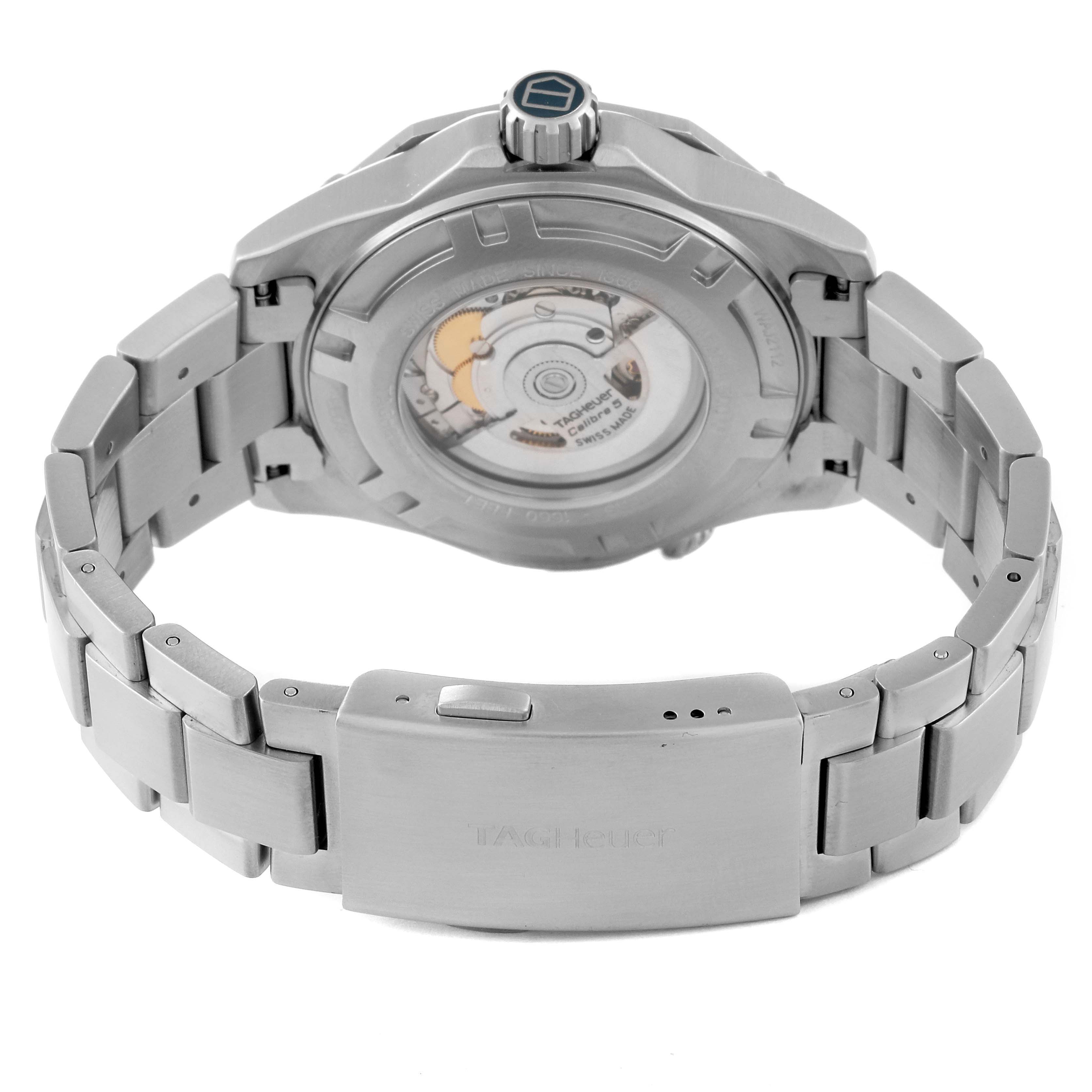 The image shows the back view of a Tag Heuer Aquaracer WAJ2112 Men's Stainless Steel Blue Dial WAJ2112 Men's Stainless Steel Blue Dial watch, highlighting the case back, movement, and bracelet with the brand name on the clasp.