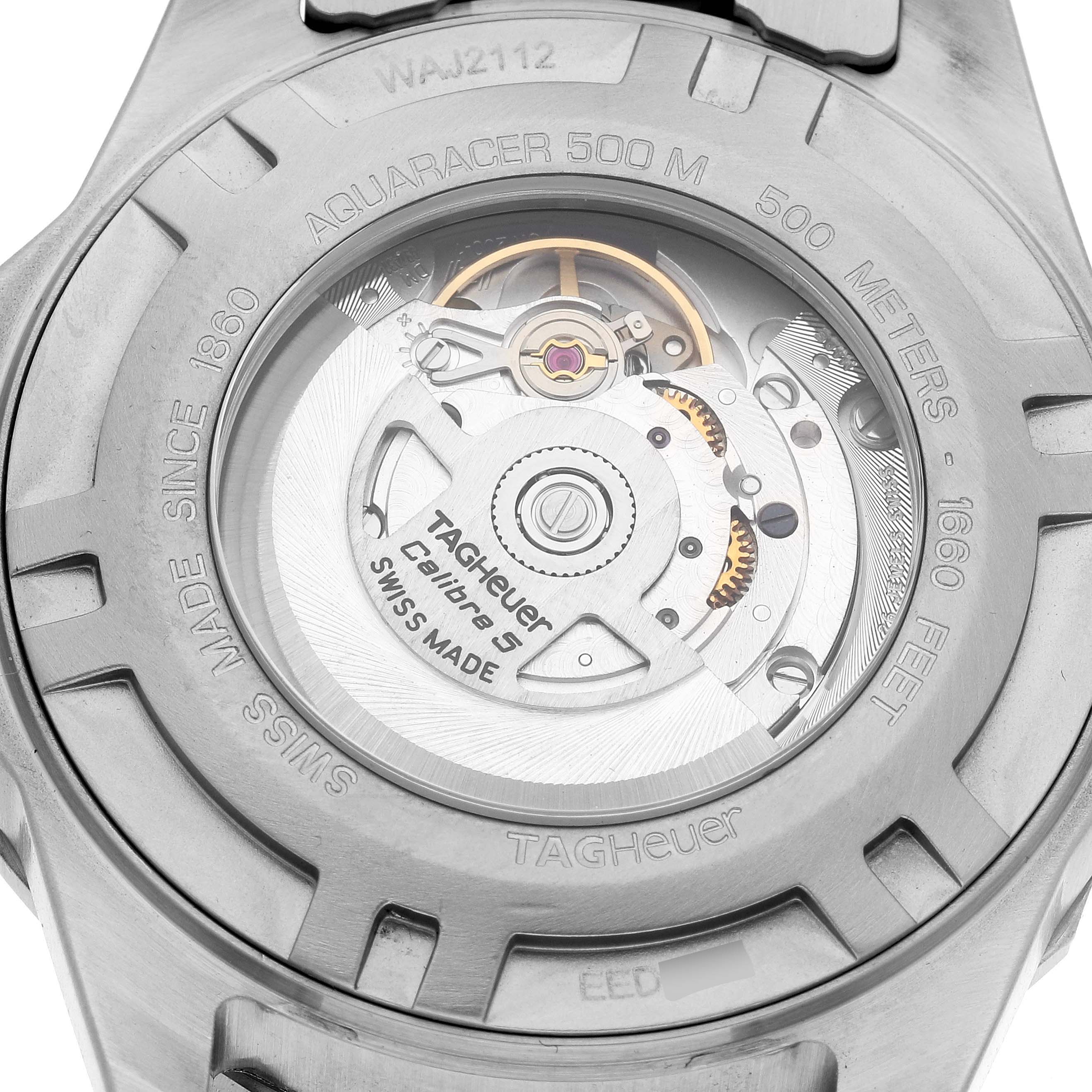 The image shows the back of the Tag Heuer Aquaracer WAJ2112 Men's Stainless Steel Blue Dial WAJ2112 Men's Stainless Steel Blue Dial watch, revealing its internal mechanism and engravings.