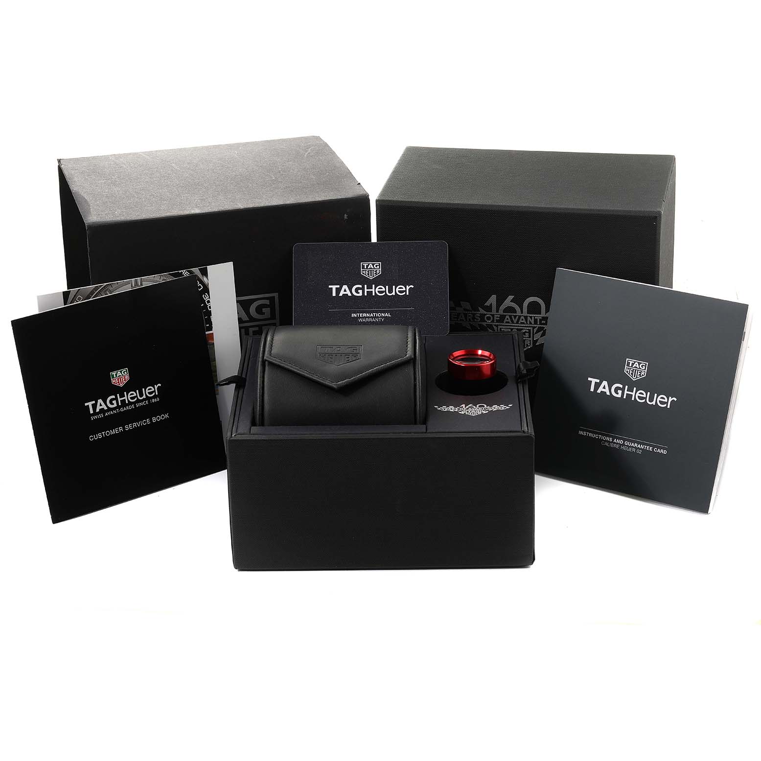 The image shows the packaging and accessories for the Tag Heuer Carrera CBN2A1D.BA0643 Men's Stainless Steel Silver Dial CBN2A1D.BA0643 Men's Stainless Steel Silver Dial model watch, including boxes, booklets, and warranty card.