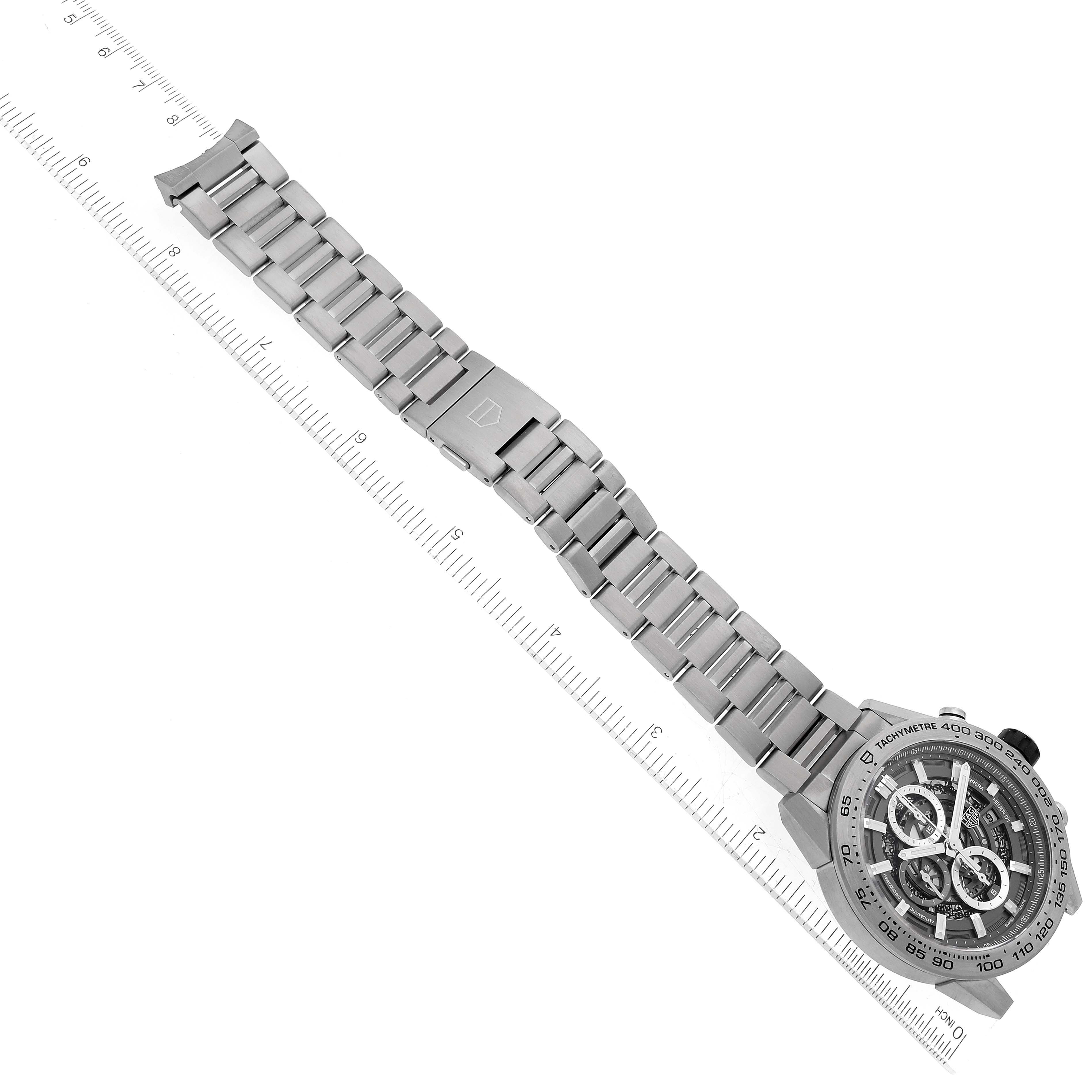 This image shows the Tag Heuer Carrera CAR2A8A.BF0707 Men's Titanium Grey Dial CAR2A8A.BF0707 Men's Titanium Grey Dial watch from a top-down angle, highlighting the face and metal bracelet with a ruler in the background.