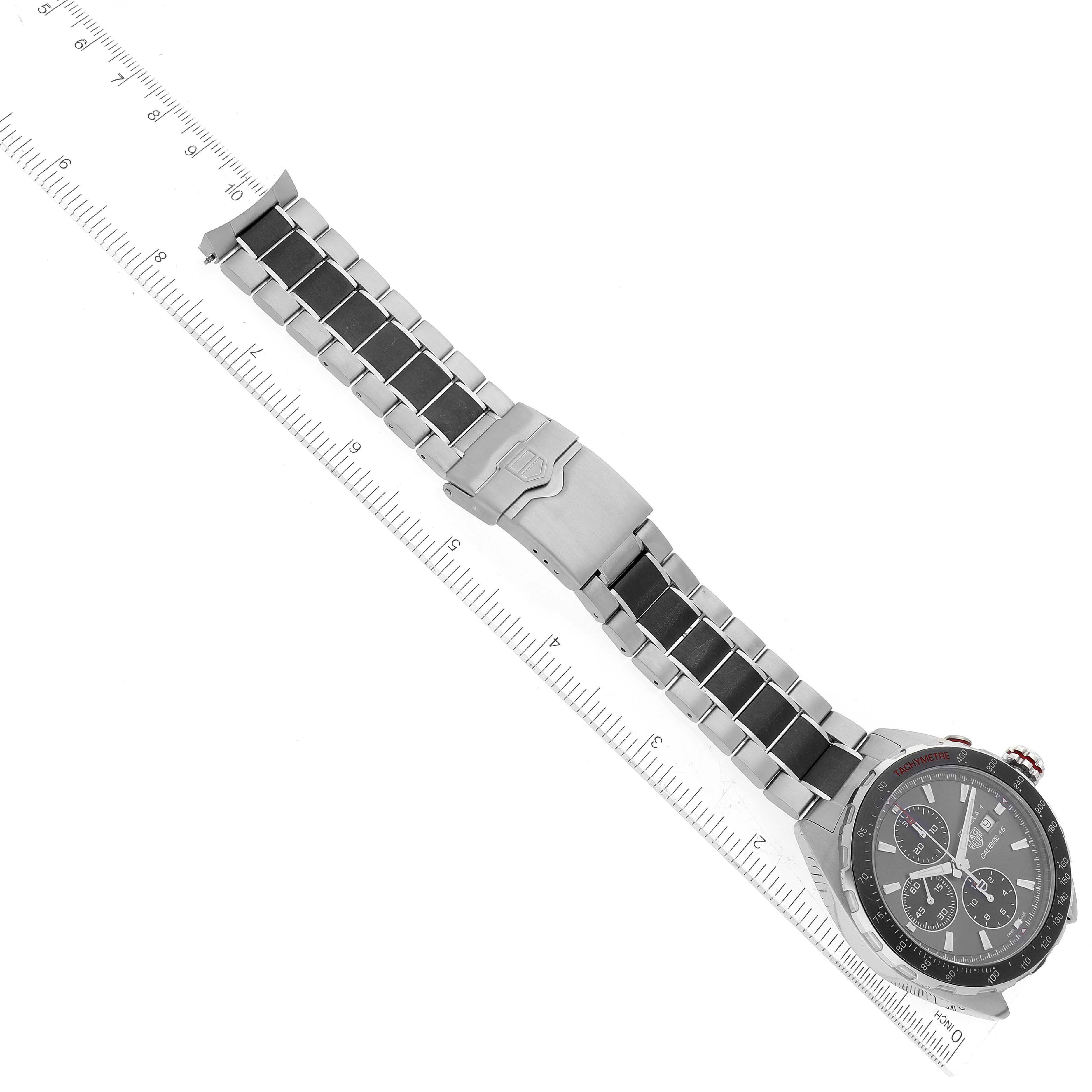 The image shows a top-down view of a Tag Heuer Formula 1 CAZ2012-0 Men's Stainless Steel Grey Dial CAZ2012-0 Men's Stainless Steel Grey Dial watch with a ruler for scale.