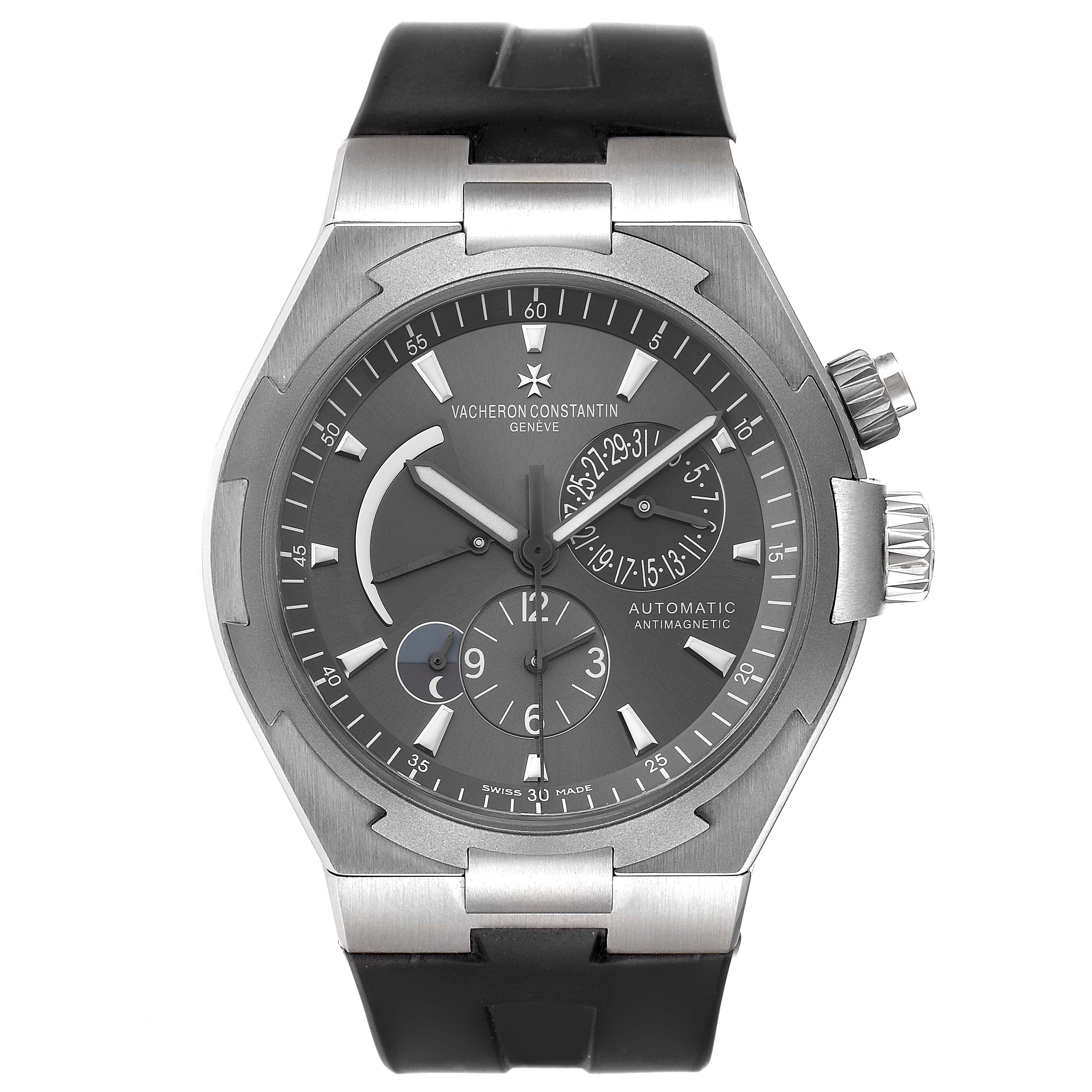 The image shows a front-facing view of a Vacheron Constantin Overseas 47450/000W-9511 Men's Stainless Steel Black Dial 47450/000W-9511 Men's Stainless Steel Black Dial model watch with a black strap and detailed dial.