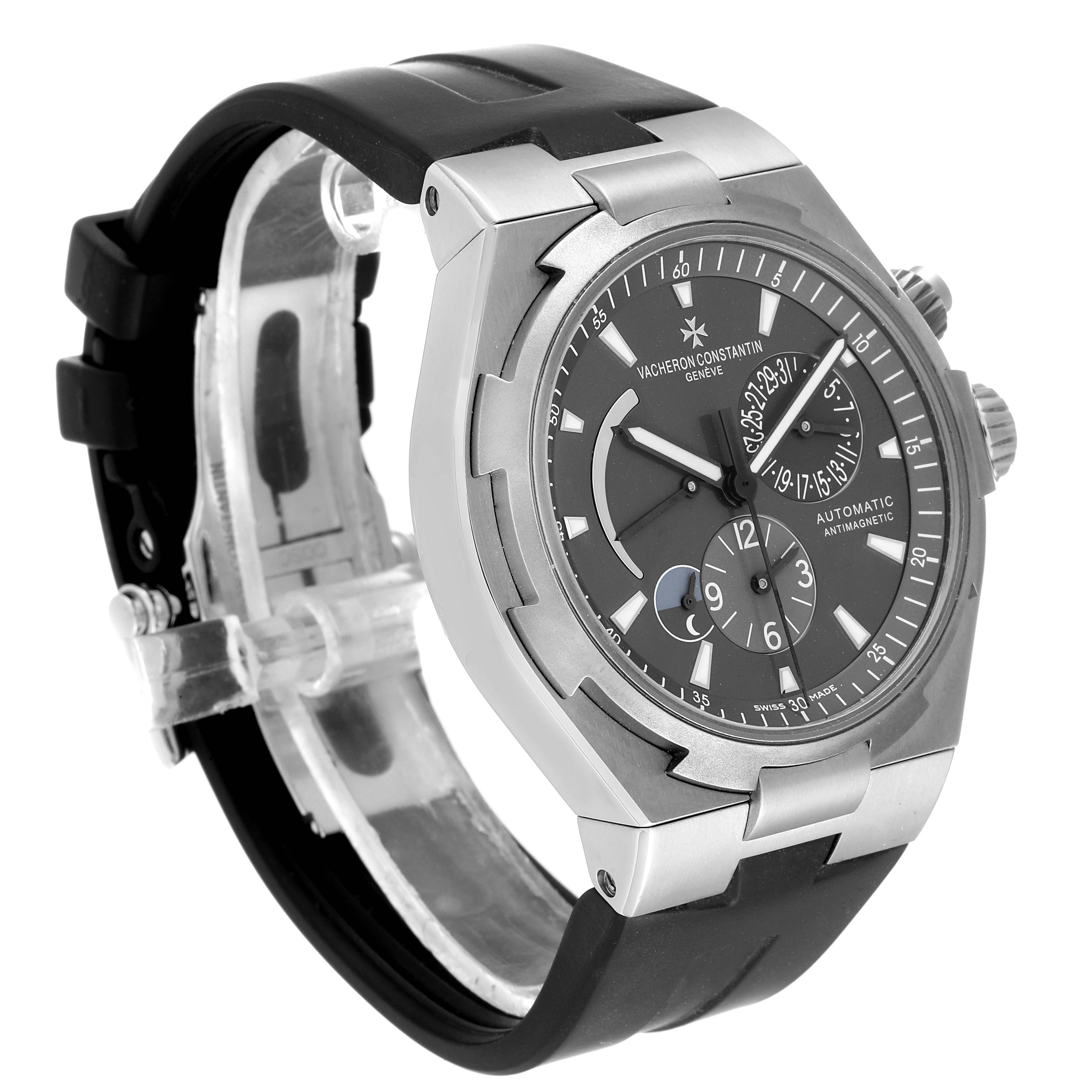 The image shows a Vacheron Constantin Overseas 47450/000W-9511 Men's Stainless Steel Black Dial 47450/000W-9511 Men's Stainless Steel Black Dial watch from a three-quarter view, highlighting the face, bezel, and rubber strap.