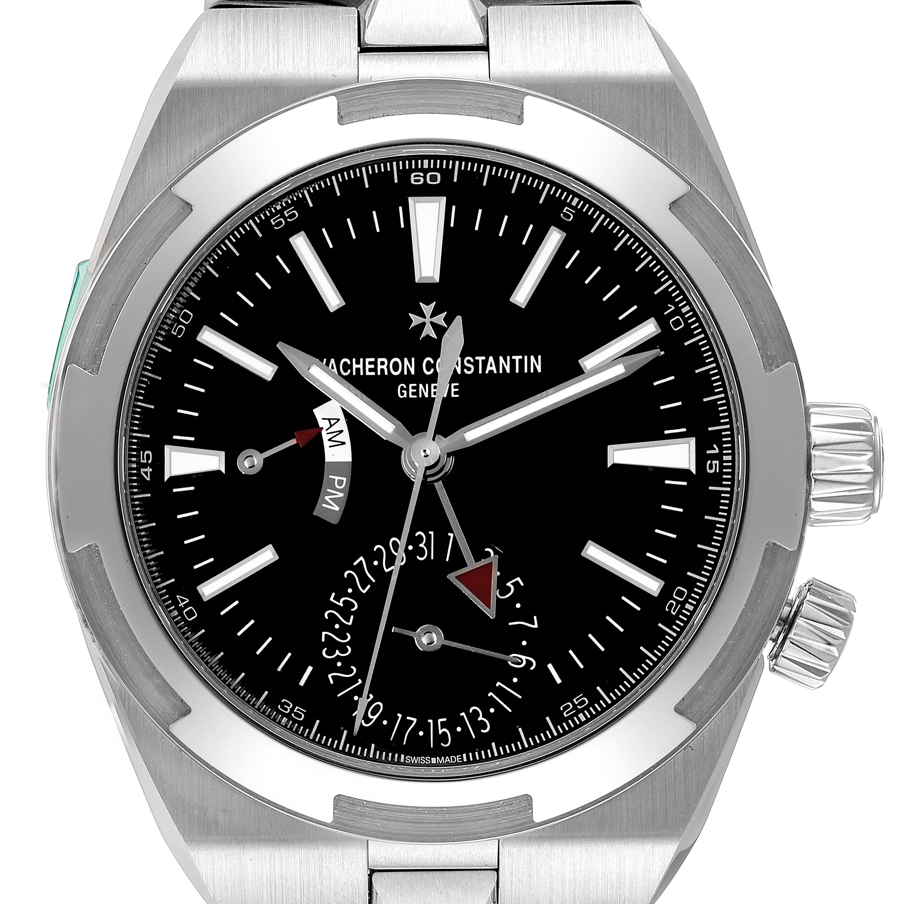 The image shows a front view of the Vacheron Constantin Overseas 7900V/110A Men
s Stainless Steel Black Dial 7900V/110A Men
s Stainless Steel Black Dial watch, displaying its black dial, hands, day/night indicator, and date function.