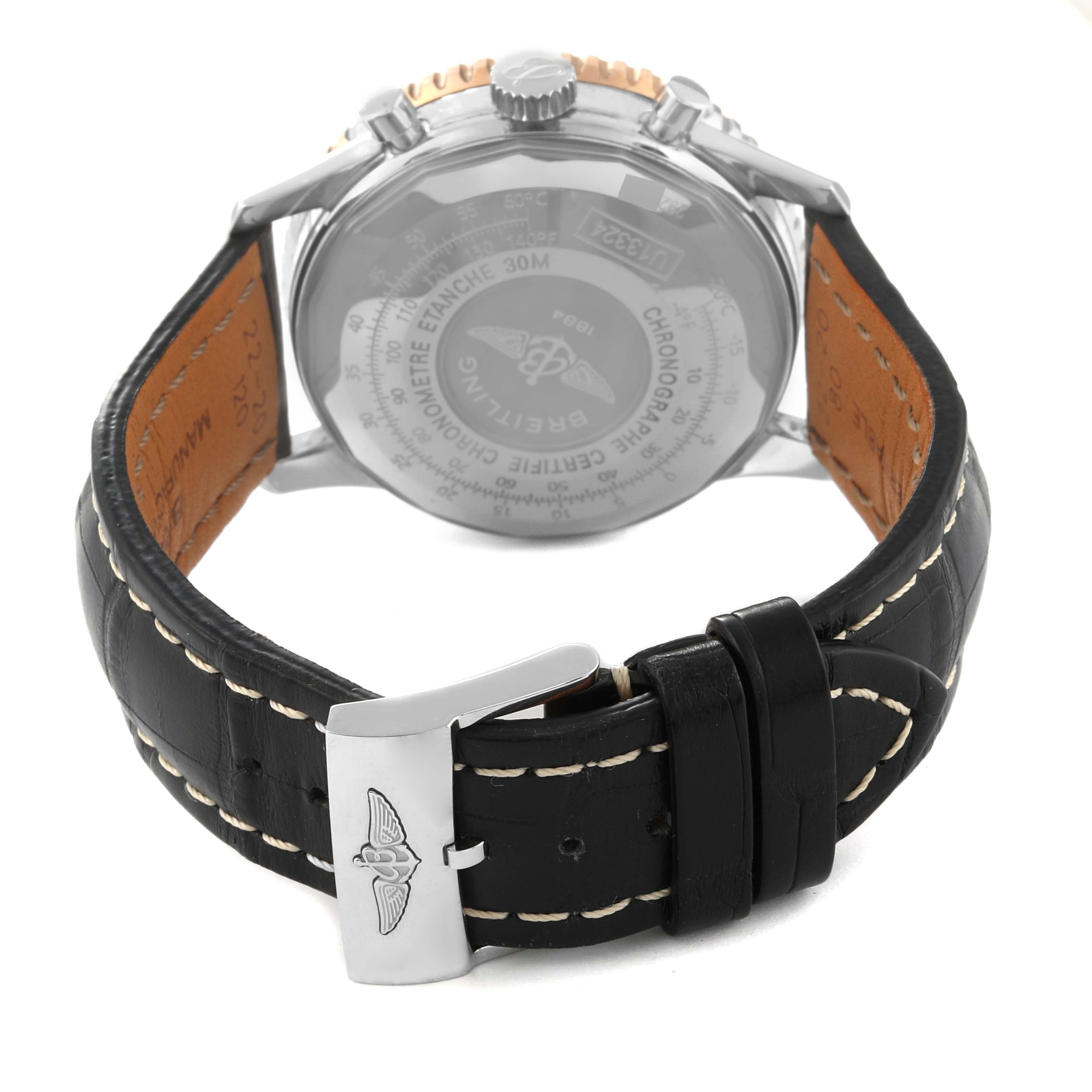 The image shows the back view of a Breitling Navitimer U13324 Men
s Steel and Gold (two tone) Black Dial U13324 Men
s Steel and Gold (two tone) Black Dial watch, highlighting the black leather strap and clasp.