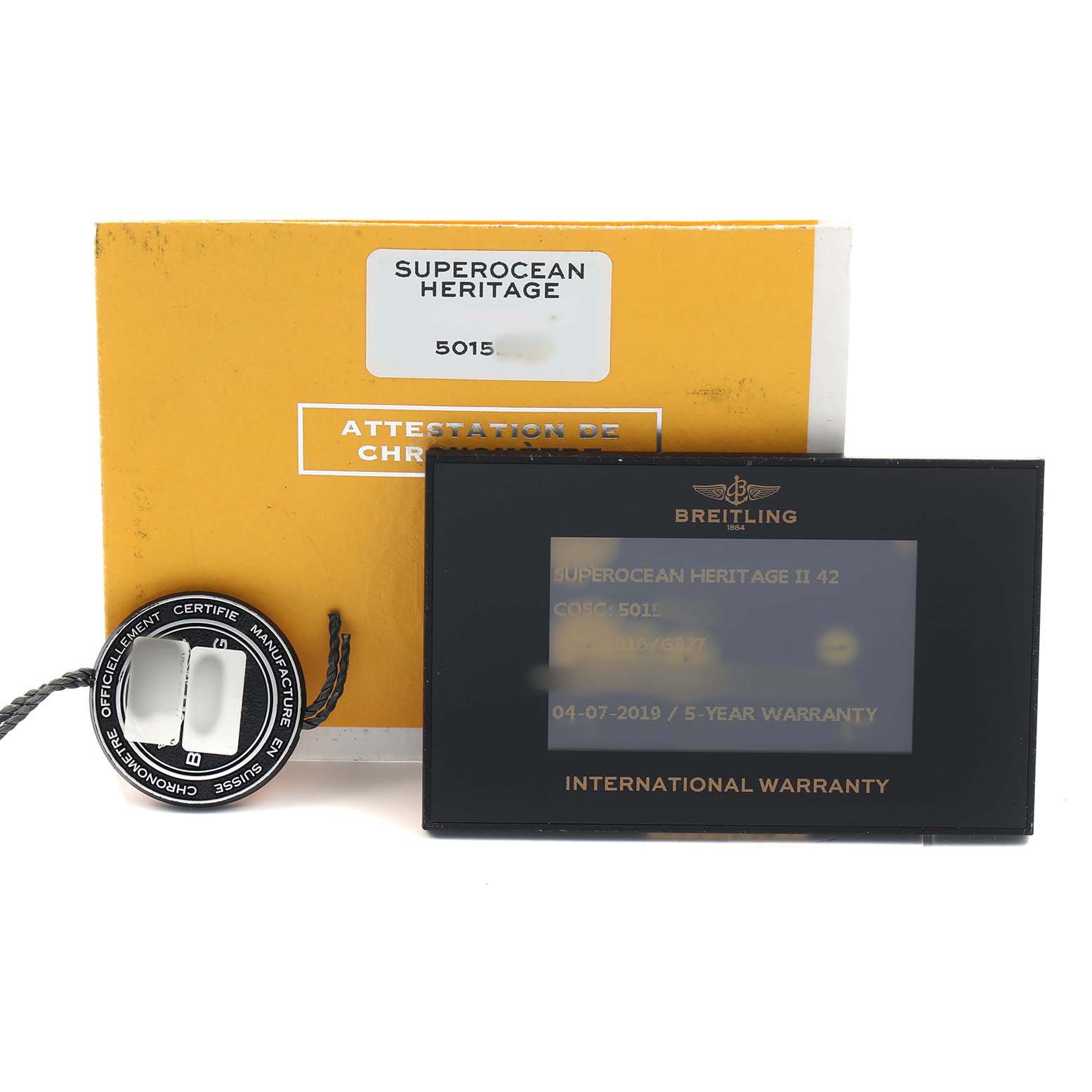 The image shows Breitling Superocean AB2010 Men's Stainless Steel Silver Dial accessories, including an authentication booklet, a tag, and a warranty card.
