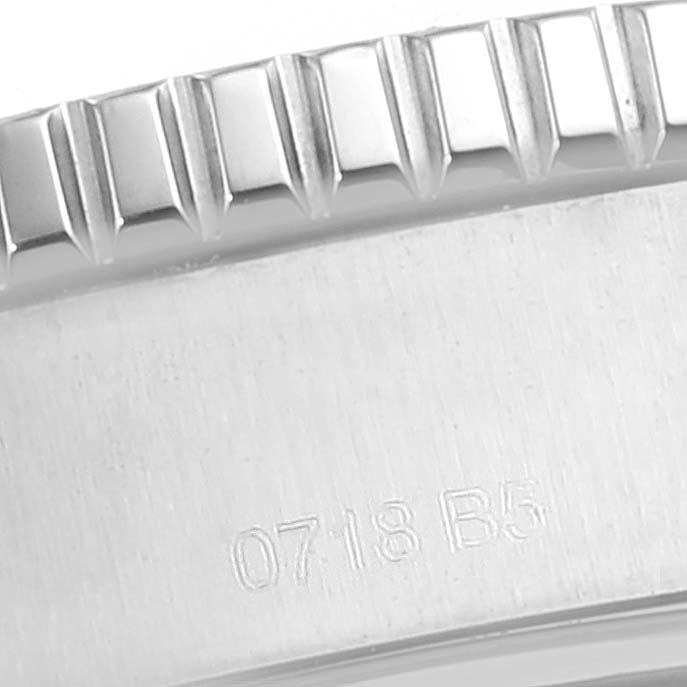 This close-up image shows part of the bezel and case back of the Breitling Superocean A17392D8/C910 Men's Stainless Steel Black Dial A17392D8/C910 Men's Stainless Steel Black Dial watch, with visible serial numbers.