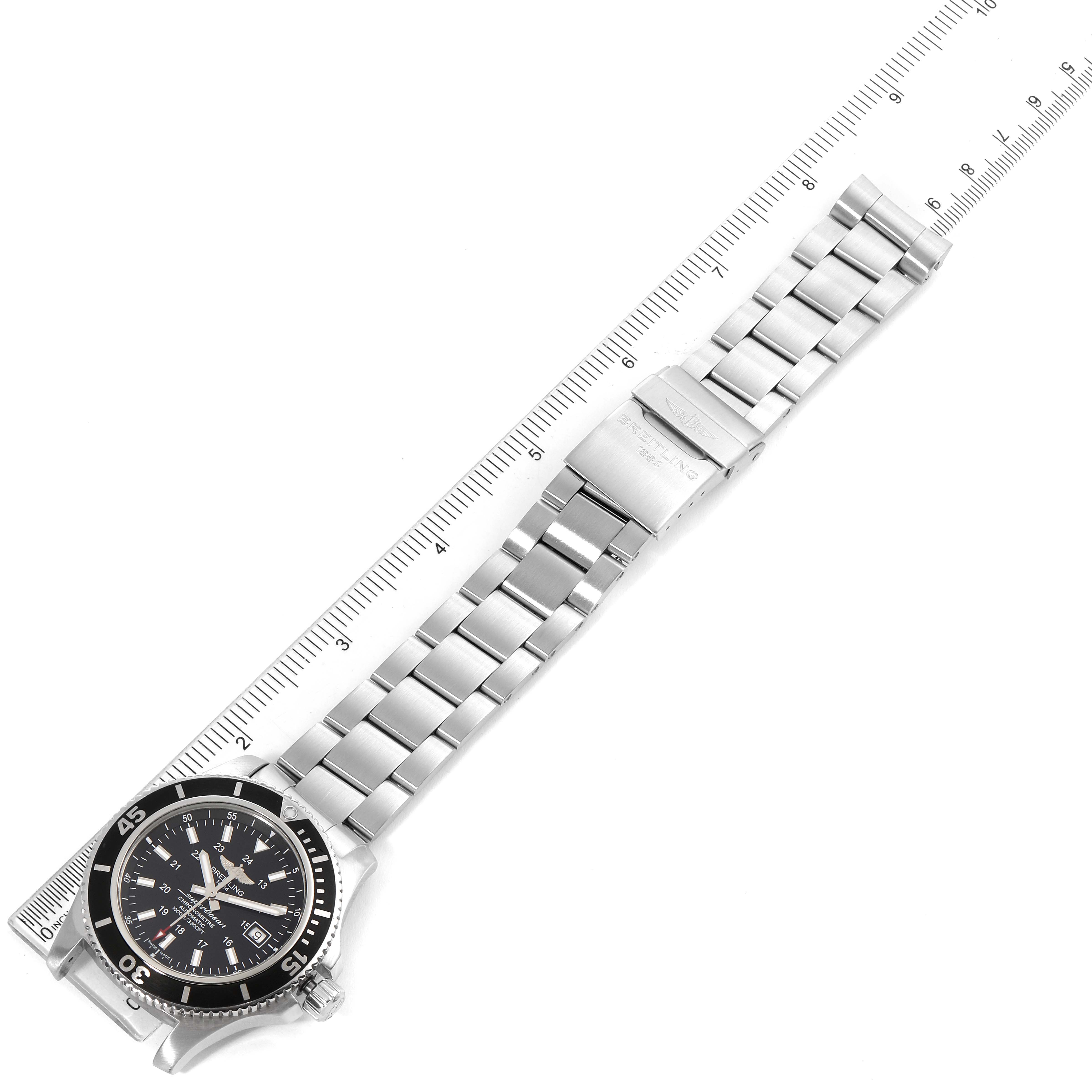 The Breitling Superocean A17392D8/C910 Men's Stainless Steel Black Dial A17392D8/C910 Men's Stainless Steel Black Dial watch is shown from a top-down angle with its full bracelet and bezel visible, alongside a ruler for size reference.