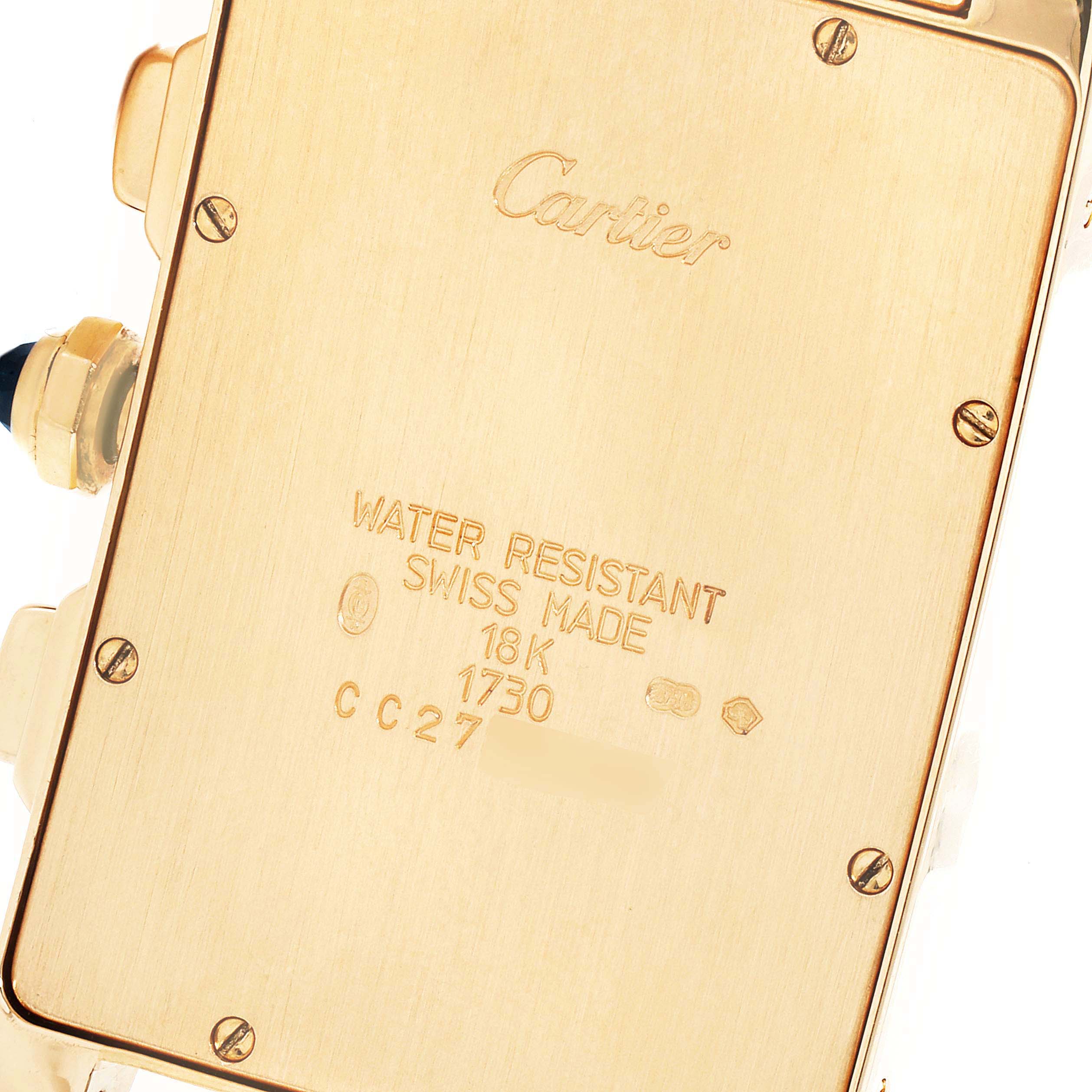 This image shows the back casing, screws, and inscriptions of the Cartier Tank Americaine W2601156 Men
s Yellow Gold Silver Dial W2601156 Men
s Yellow Gold Silver Dial watch.
