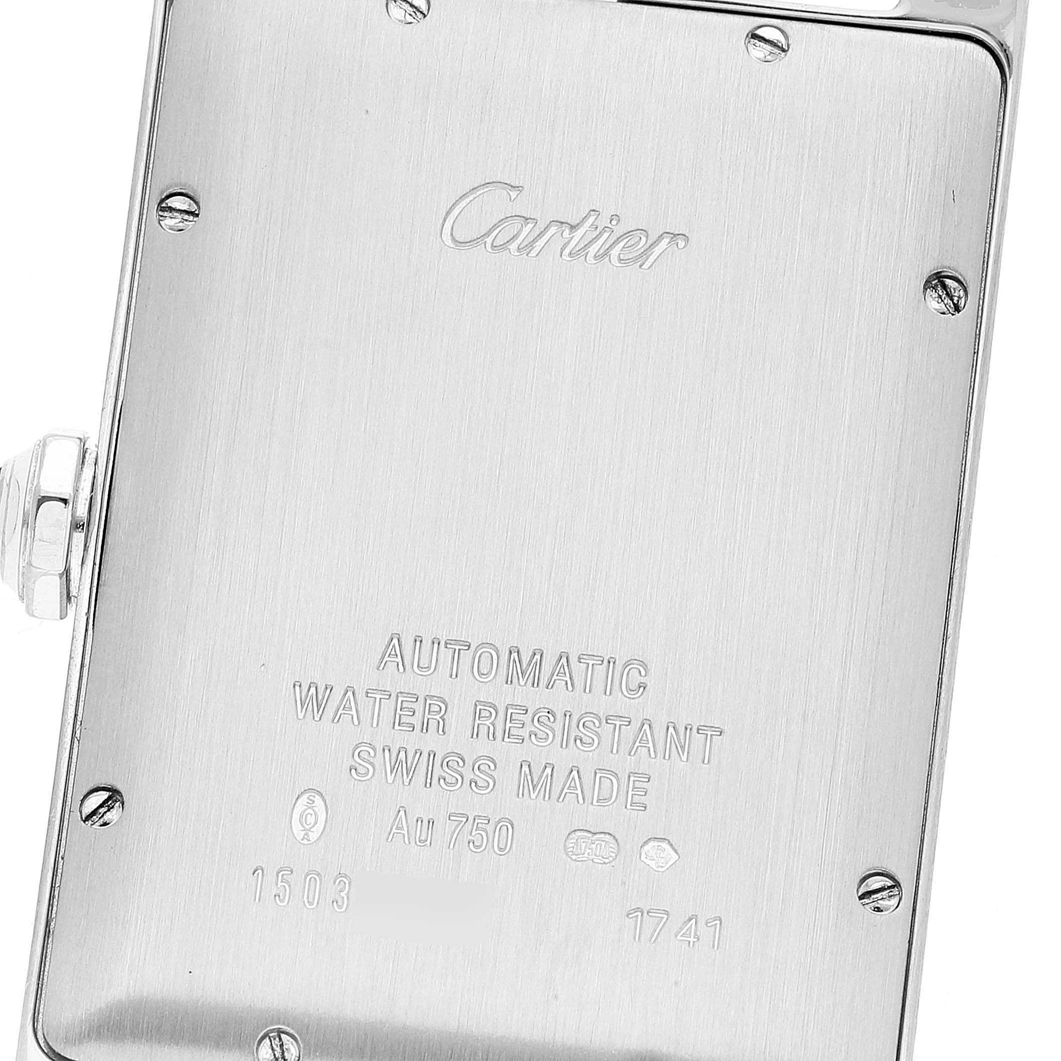 The image shows the back casing of the Cartier Tank Americaine W2603256 Men's White Gold Silver Dial W2603256 Men's White Gold Silver Dial watch, showcasing engravings and screws.