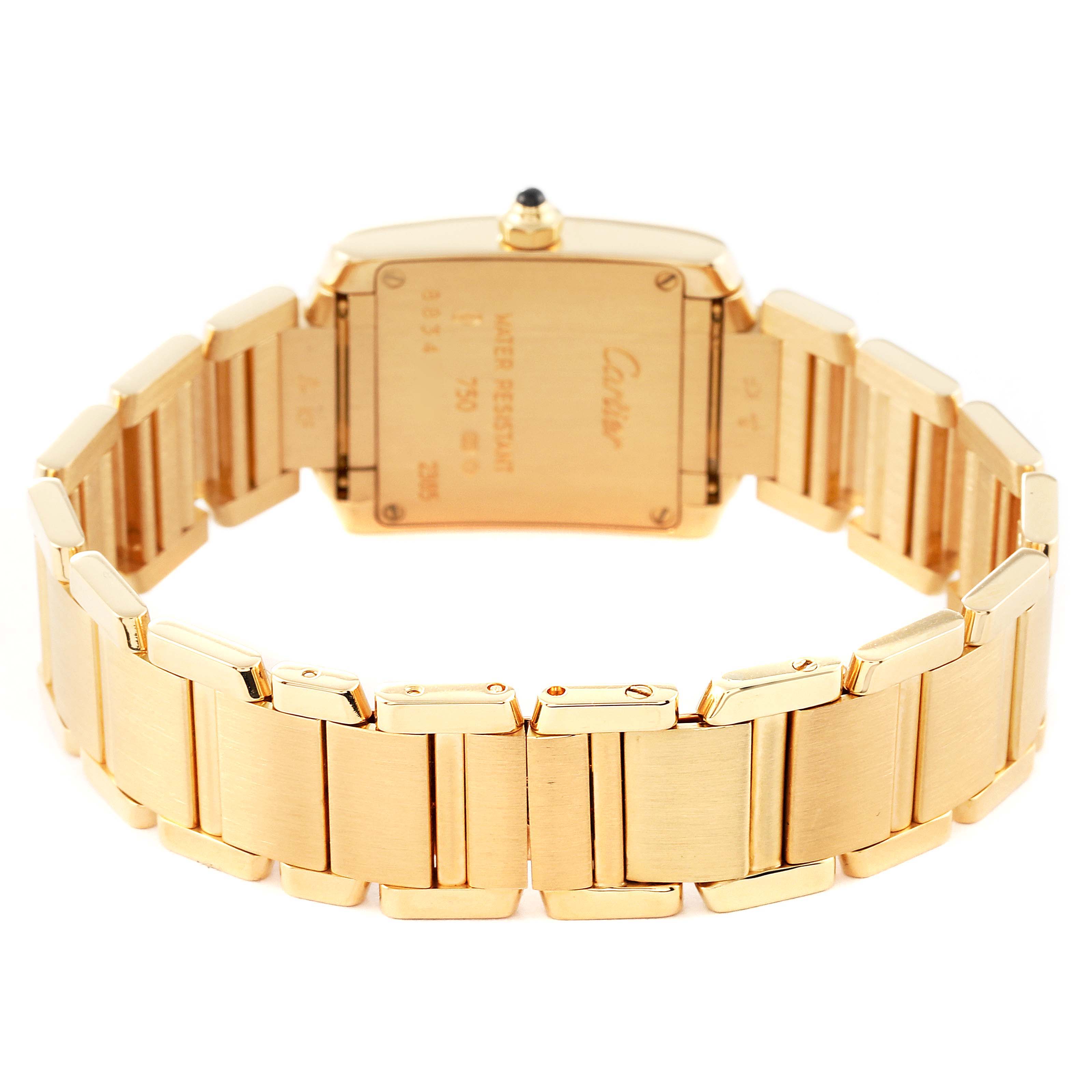 The image shows the back of the Cartier Tank Française watch, highlighting its gold case and bracelet.