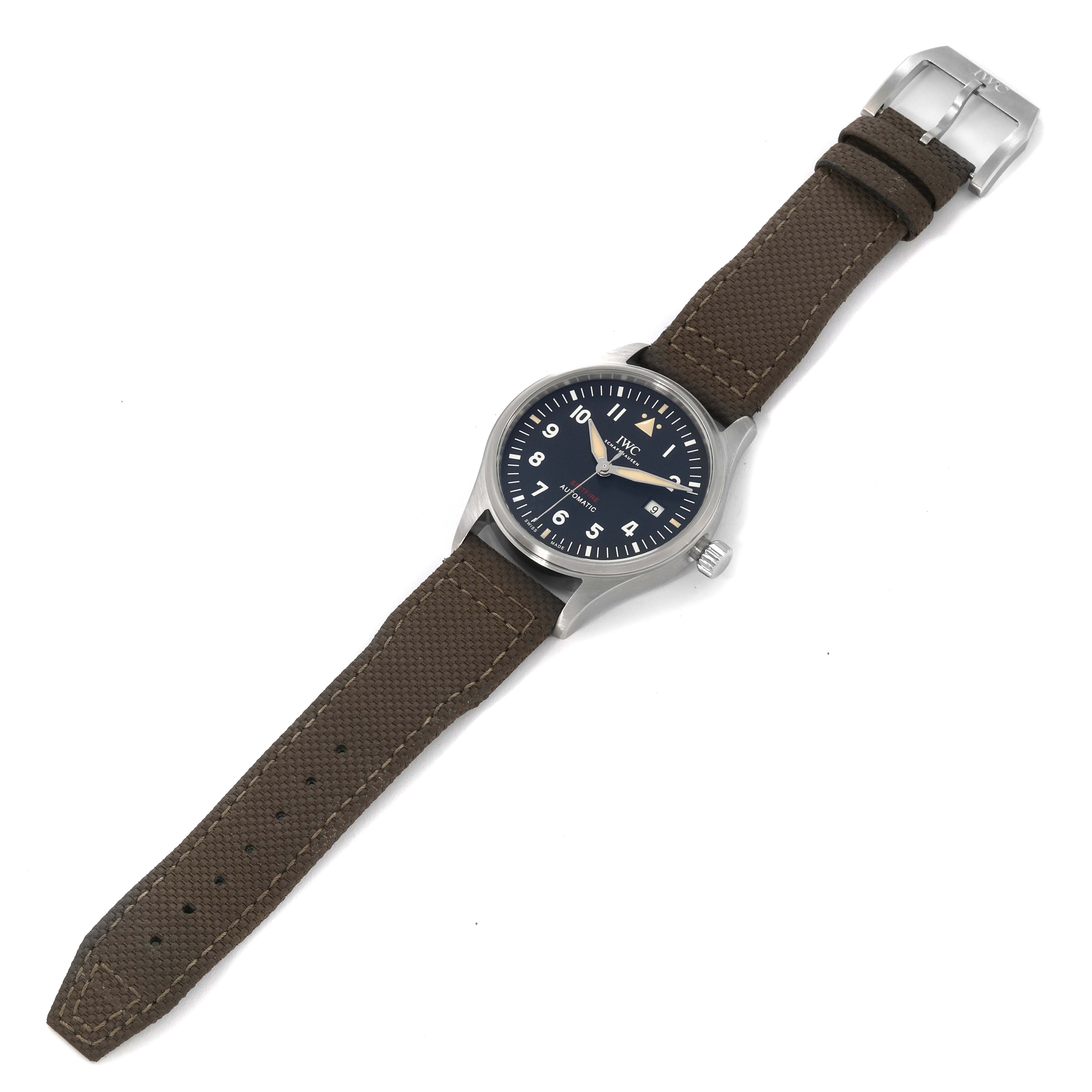 The image shows an IWC Pilot IW326801 Men's Stainless Steel Black Dial IW326801 Men's Stainless Steel Black Dial model watch laid flat, displaying the dial, brown strap, and buckle.