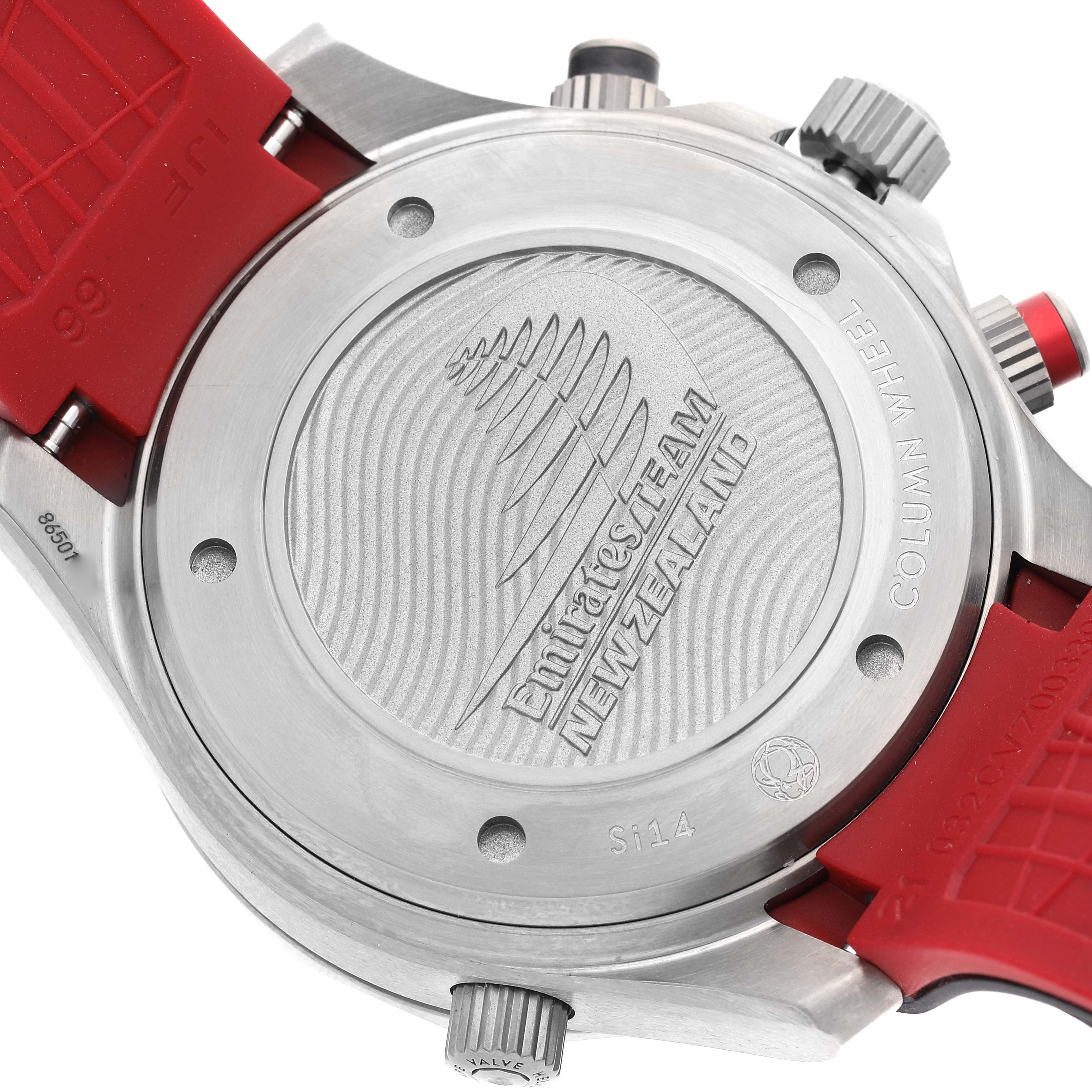 The image shows the back case of an Omega Seamaster 212.92.44.50.99.001 Men's Titanium Grey Dial 212.92.44.50.99.001 Men's Titanium Grey Dial watch, highlighting "EMIRATES TEAM NEW ZEALAND" engraving and red straps.