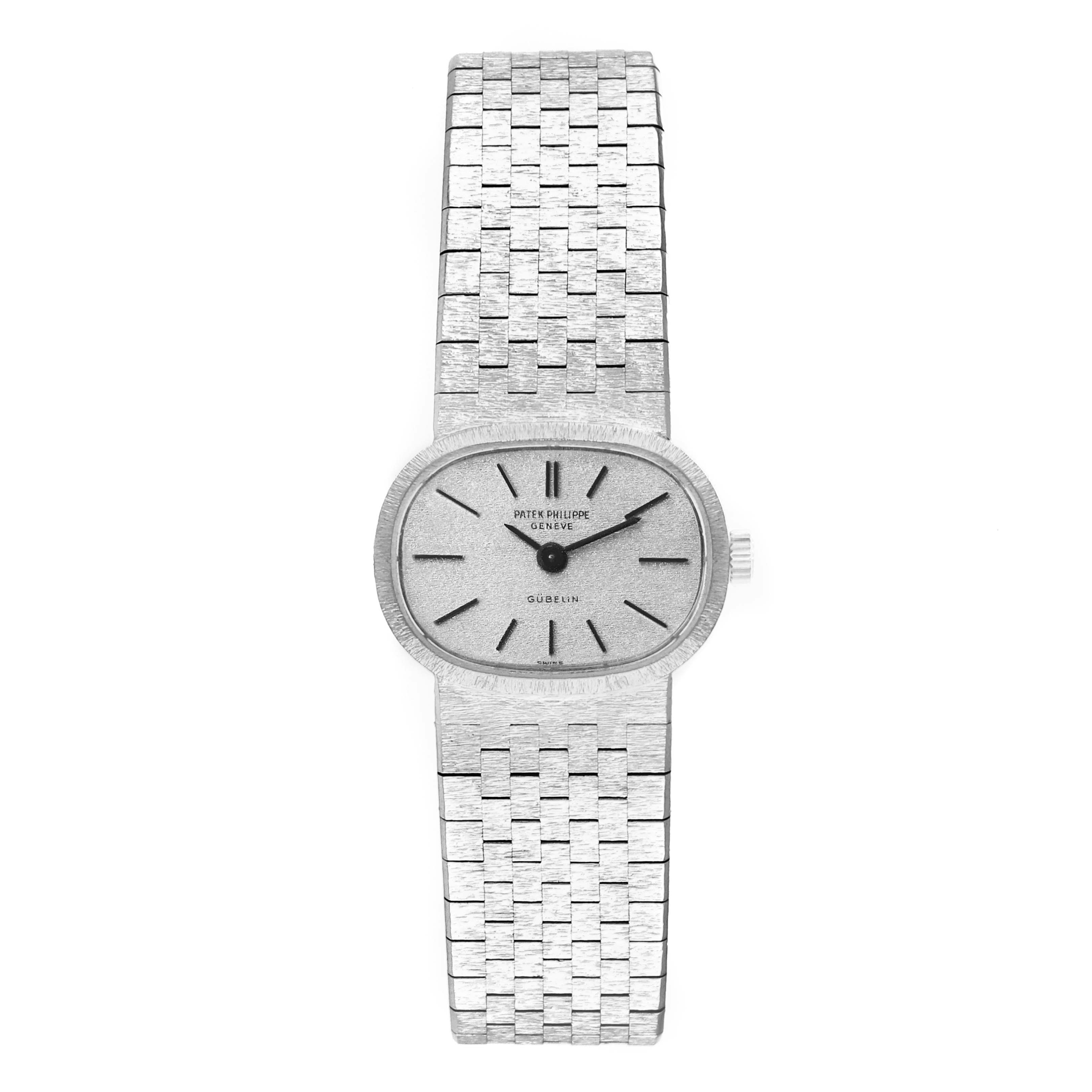 The image shows a frontal view of a Vintage Patek Philippe watch featuring a brushed metal bracelet and an oval dial.