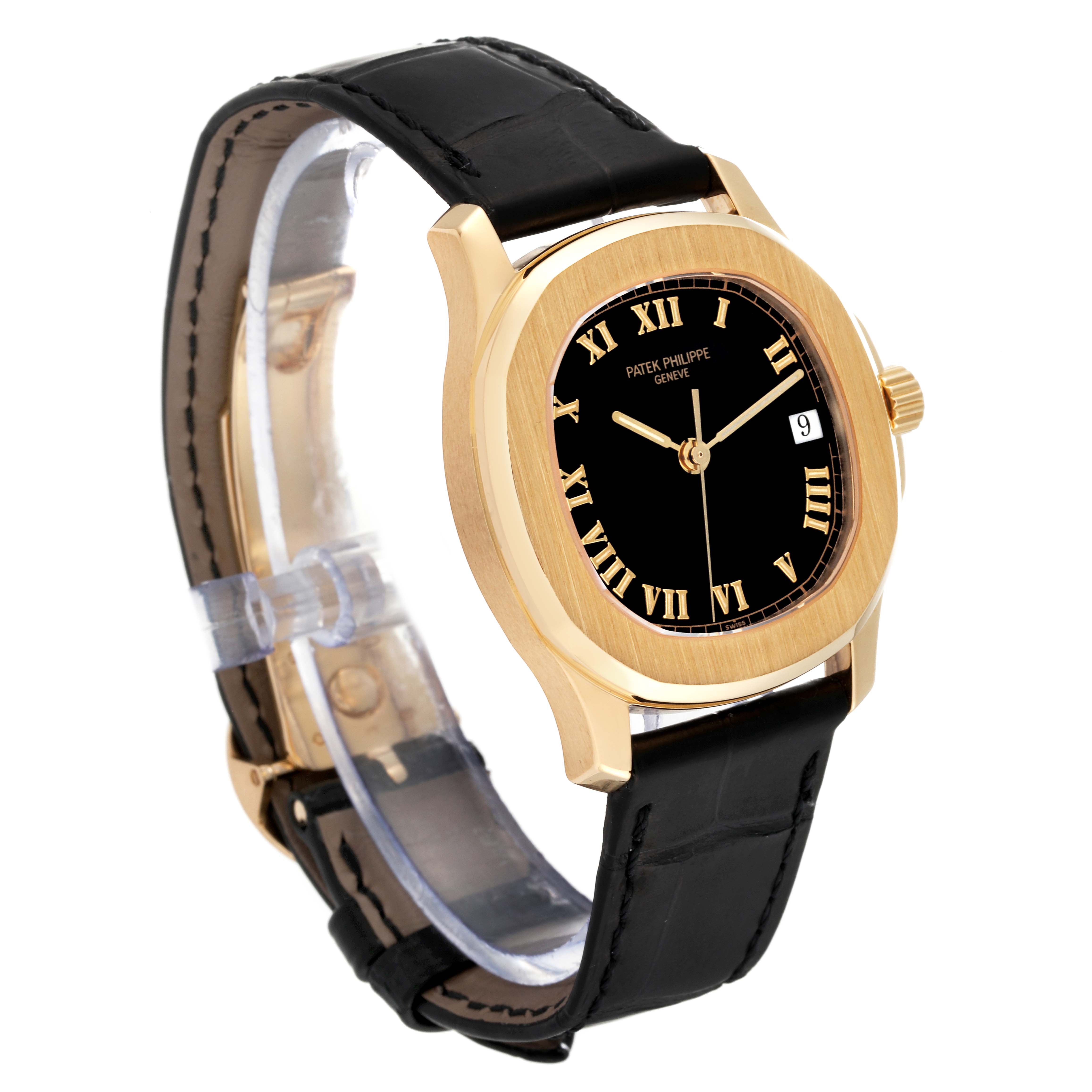 The image shows a Patek Philippe Aquanaut 5060J Men's Yellow Gold Black Dial 5060J Men's Yellow Gold Black Dial model watch with a gold case, black dial, Roman numerals, and black leather strap viewed from an angle.