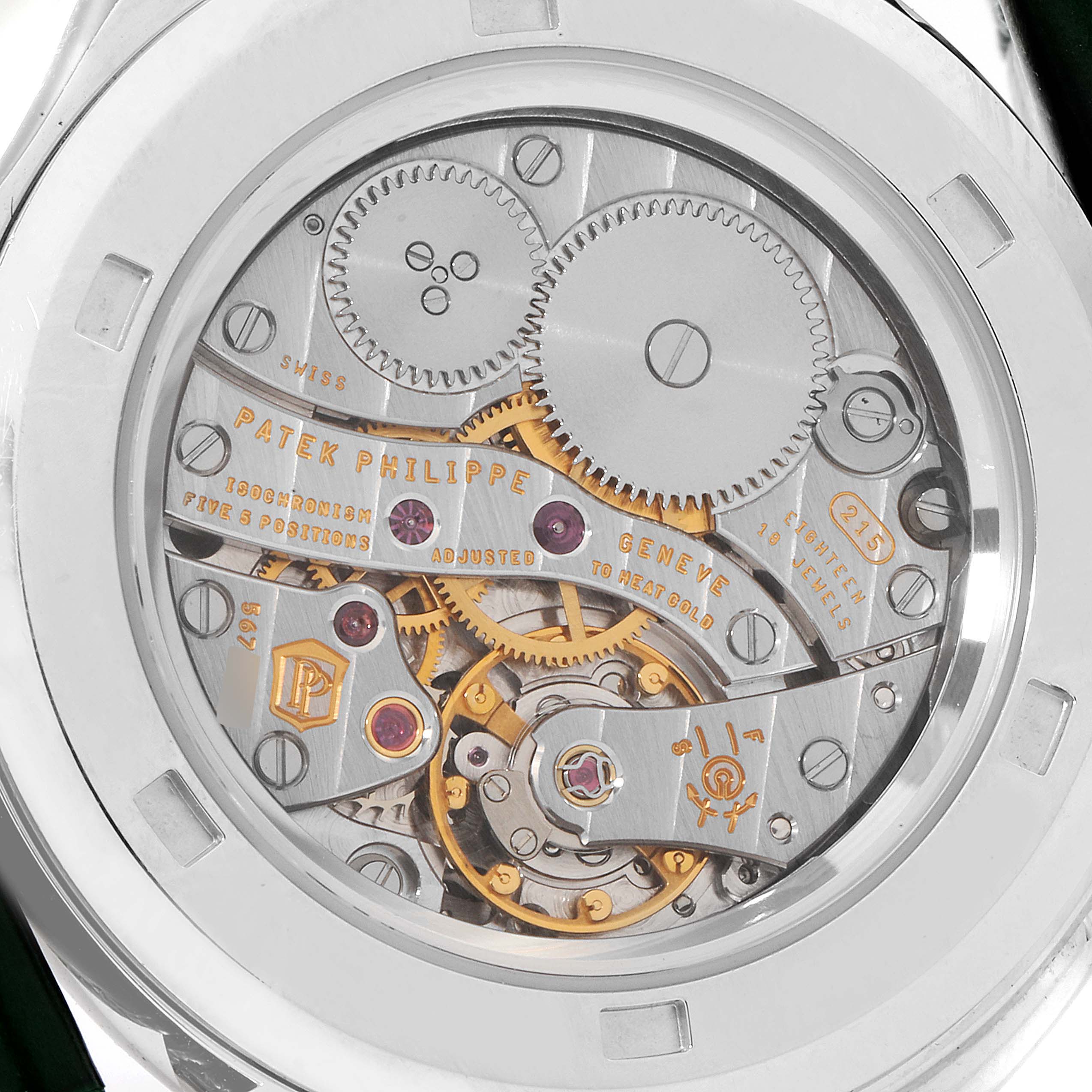 The image shows the back view of a Calatrava watch by Patek Philippe, showcasing its intricate mechanical movements.