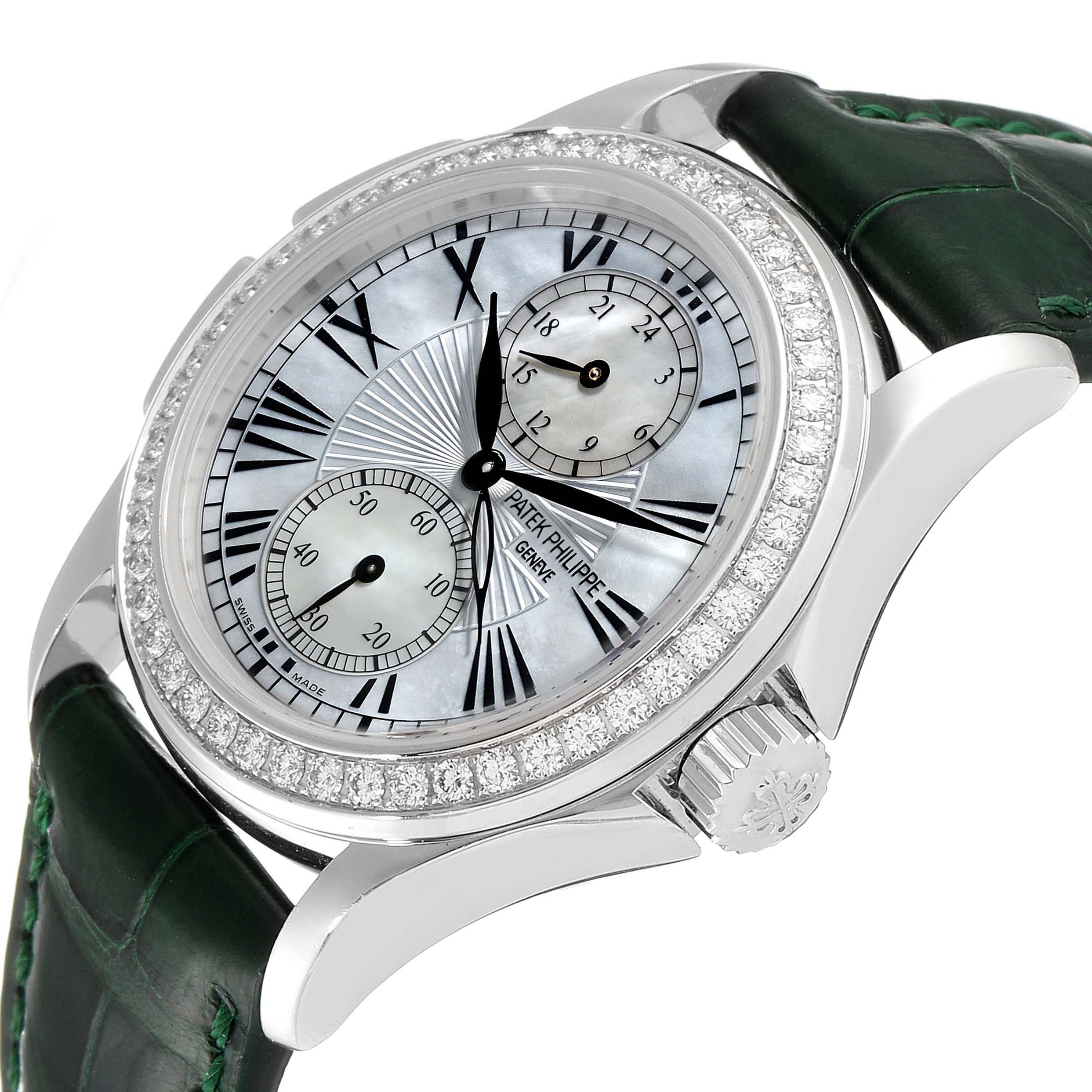 The image shows a Patek Philippe Calatrava 4934G Women's White Gold Mother of Pearl Dial 4934G Women's White Gold Mother of Pearl Dial watch at an angle highlighting its pearl dial, diamond bezel, and dark green leather strap.