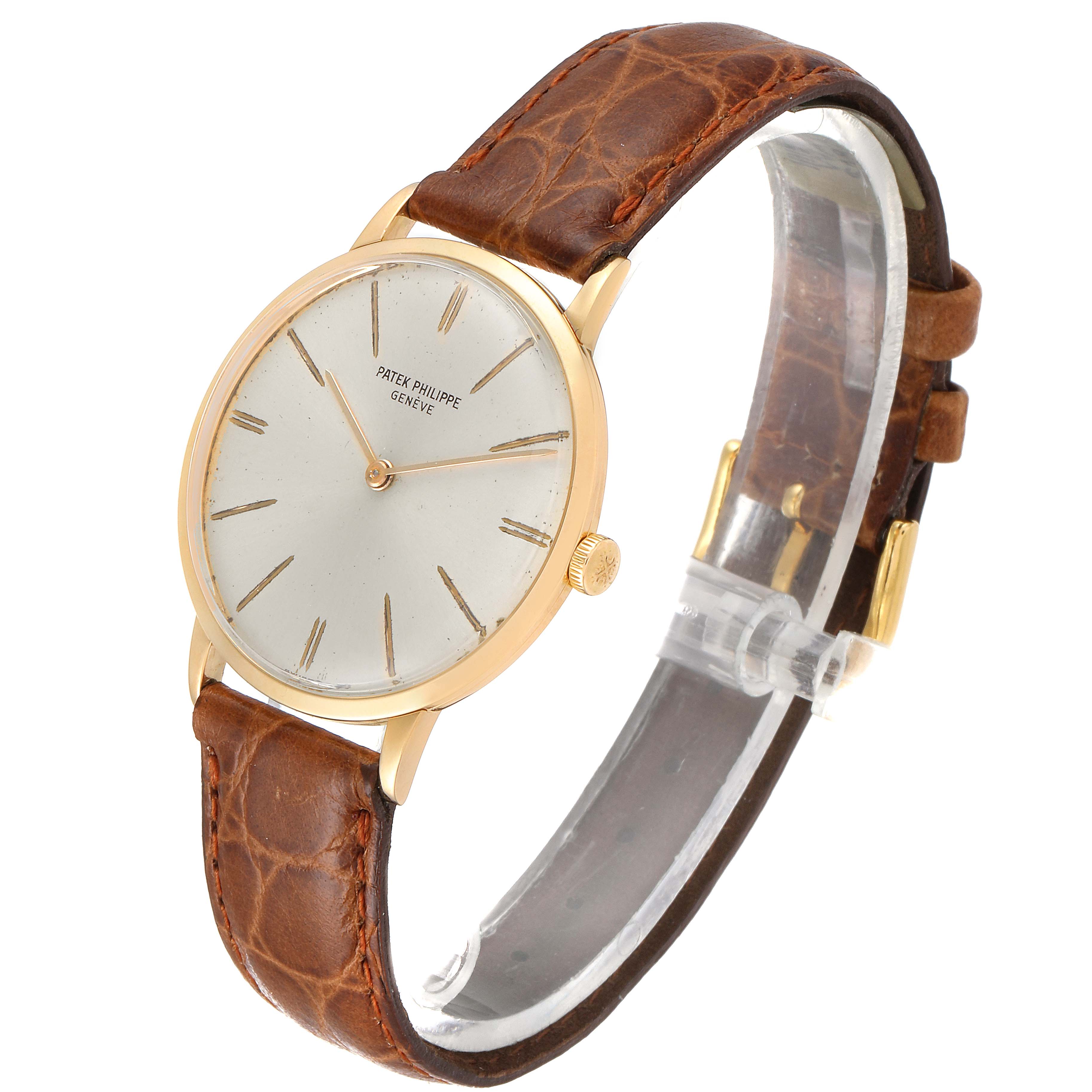 The Patek Philippe Vintage model is shown at a slight angle, displaying the face, brown leather strap, and gold casing.