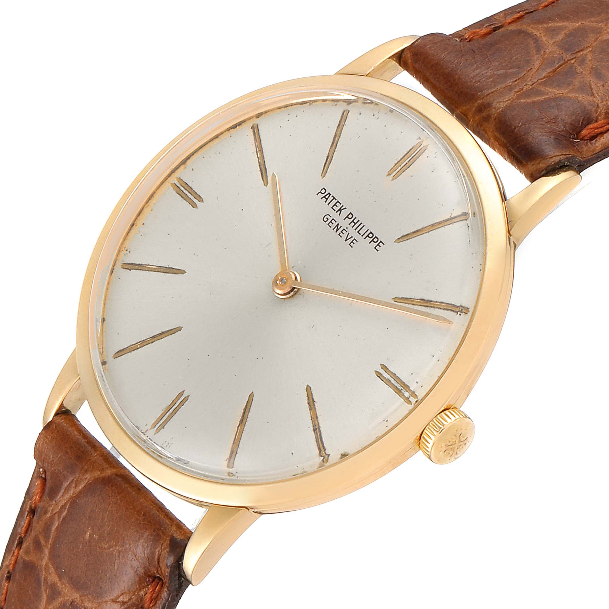 The image shows a vintage Patek Philippe watch from a slightly angled top view, highlighting its face, bezel, crown, and brown leather strap.