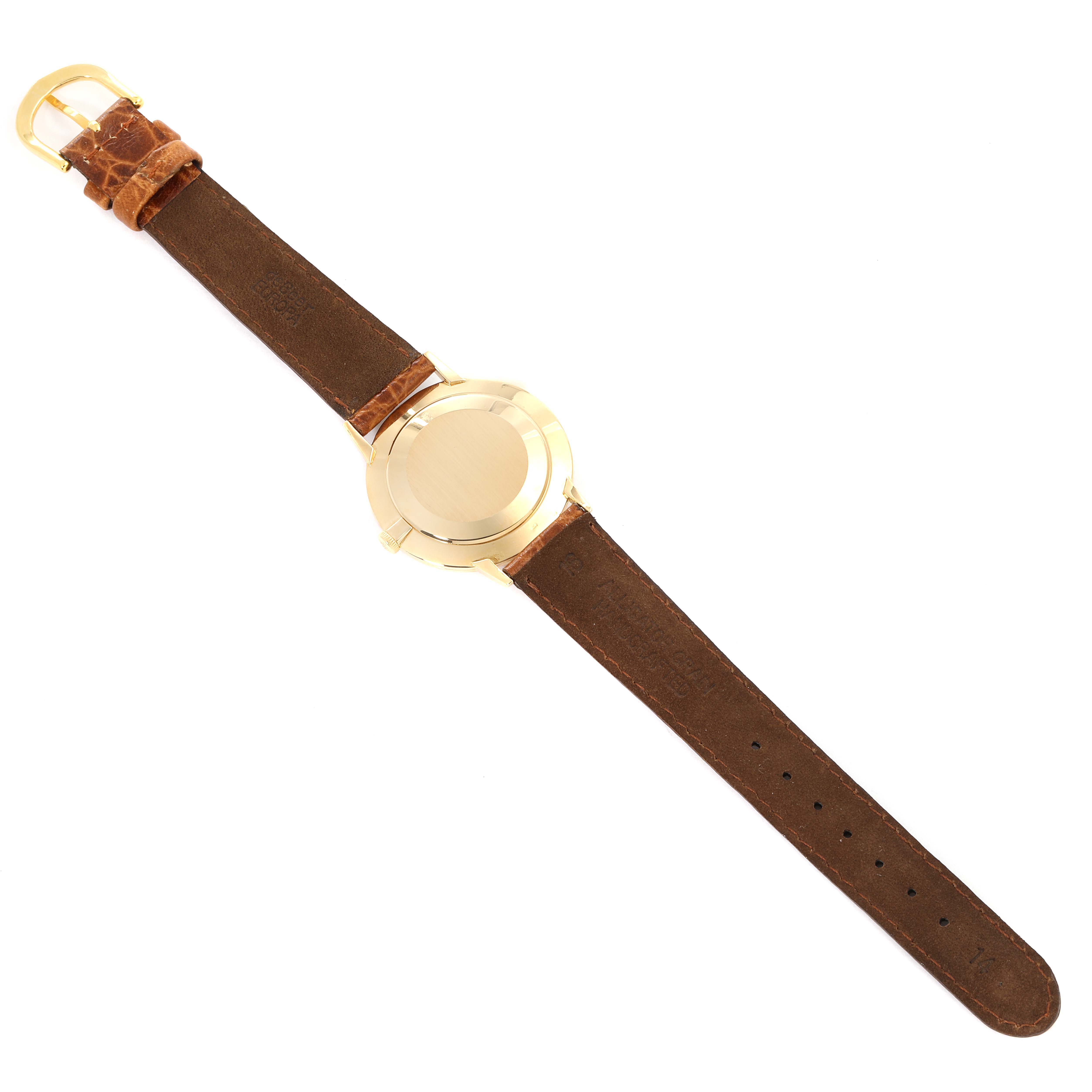 The image shows the back view of a Vintage Patek Philippe watch, highlighting its leather strap and gold case.