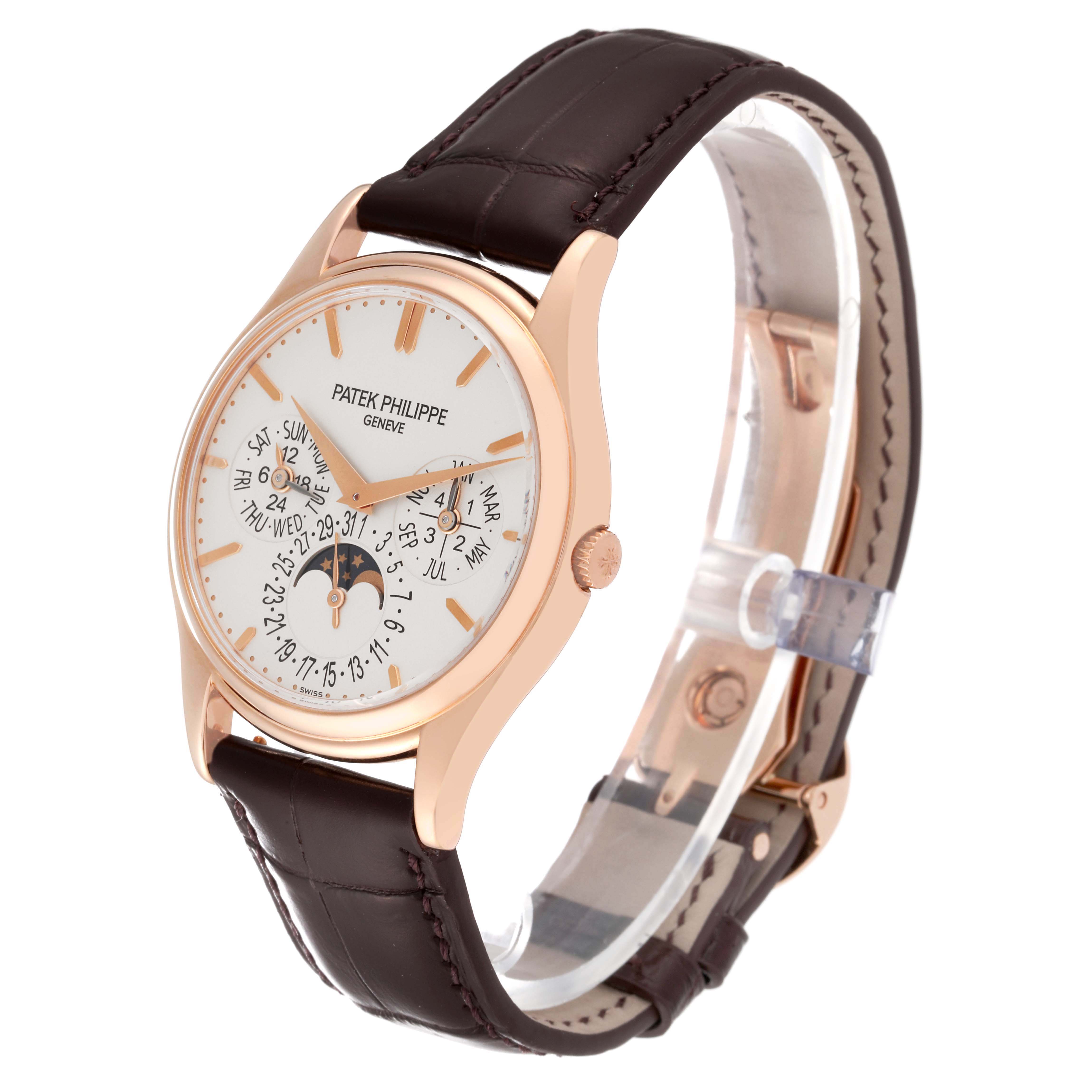 This image shows a Patek Philippe Complications 5140R-001 Men
s Rose Gold Silver Dial 5140R-001 Men
s Rose Gold Silver Dial model watch at a 3/4 angle, displaying the face, bezel, and strap.