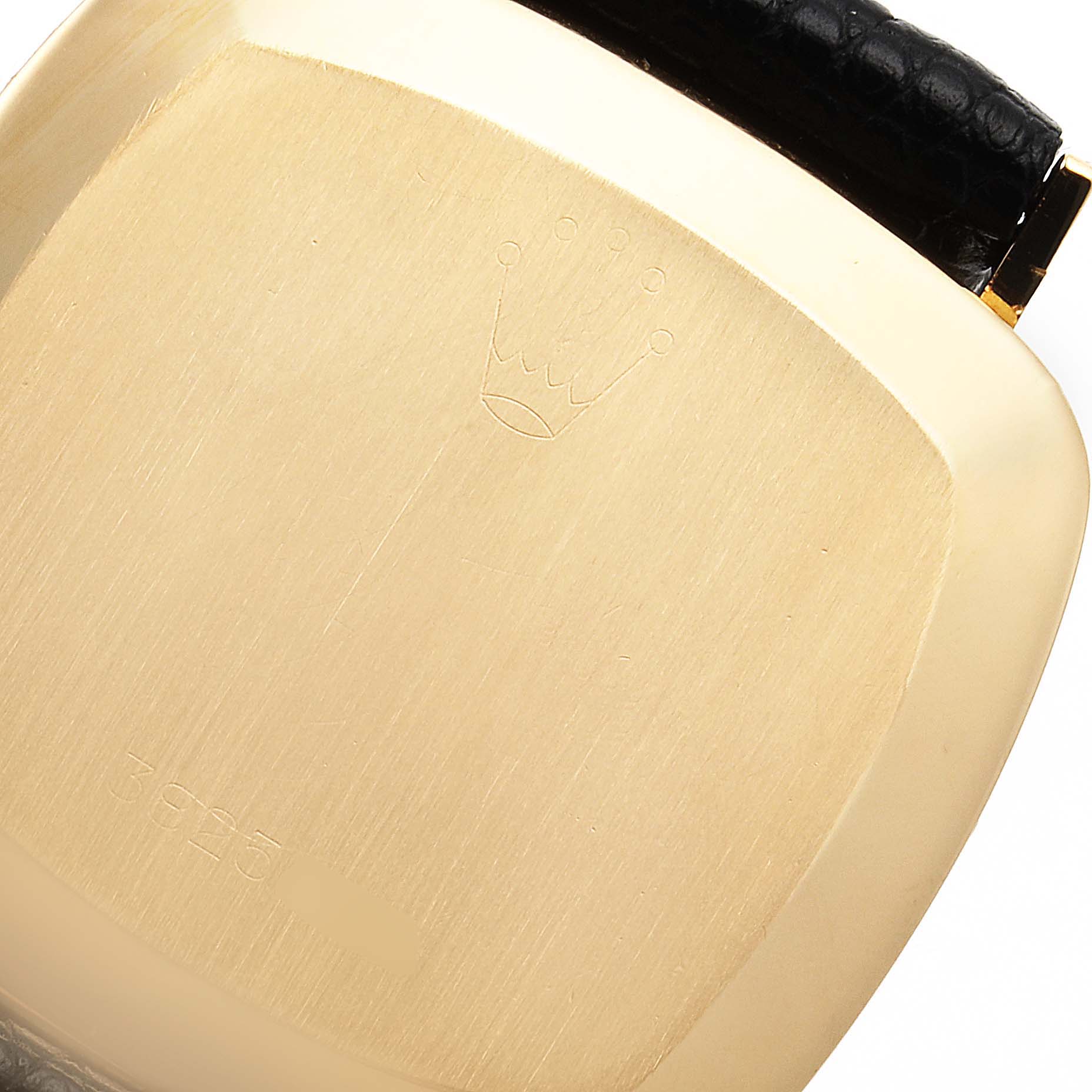 This image shows the back case of a Rolex Cellini 4084 Men's Yellow Gold Champagne Dial 4084 Men's Yellow Gold Champagne Dial watch, highlighting the crown logo and part of the black leather strap.