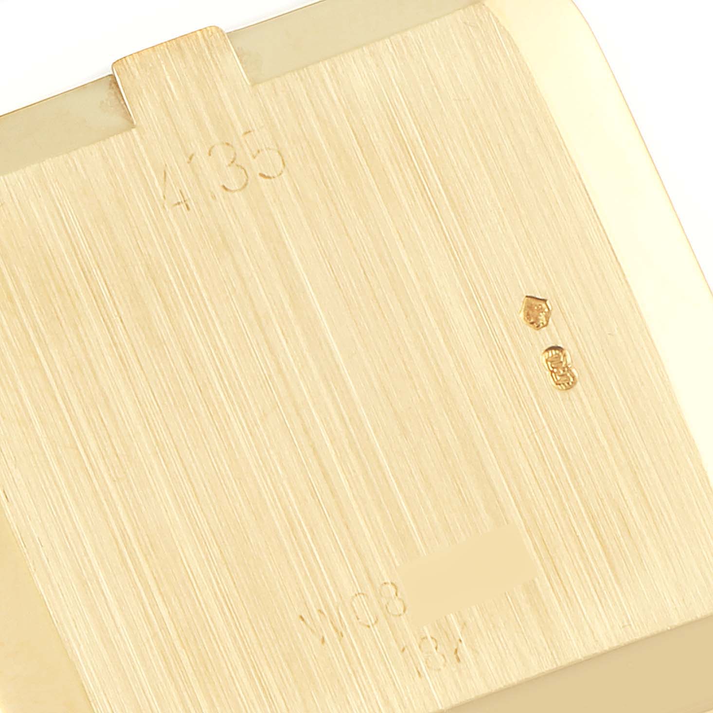 The image shows the back case cover of the Rolex Cellini 4135 Men's Yellow Gold Champagne Dial 4135 Men's Yellow Gold Champagne Dial model, viewed close-up to highlight engraving and hallmarks.