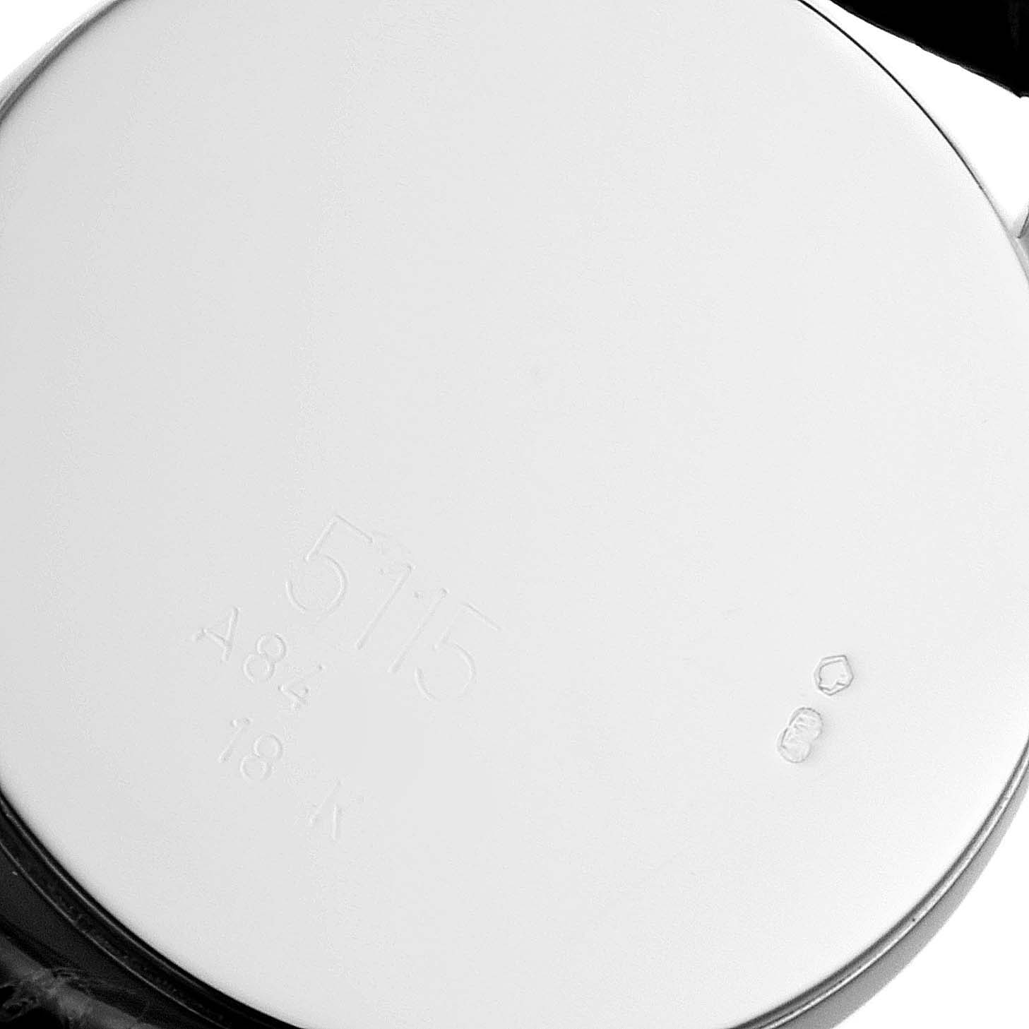 This is an image of the back case of a Rolex Cellini 5115 Men's White Gold Black Dial 5115 Men's White Gold Black Dial model, showing its engravings and markings.