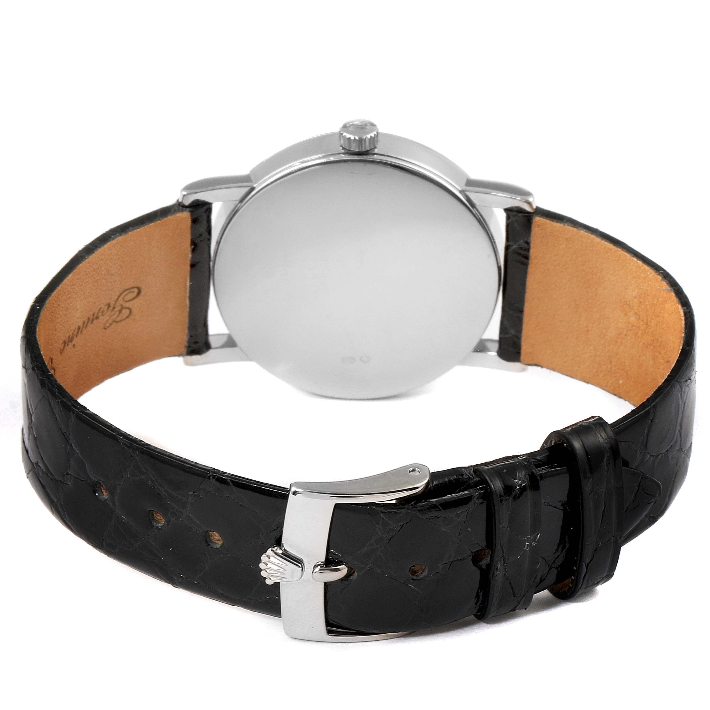 The image shows the back of a Rolex Cellini 5115 Men's White Gold Black Dial 5115 Men's White Gold Black Dial watch, displaying its case, crown, and black leather strap with a buckle.