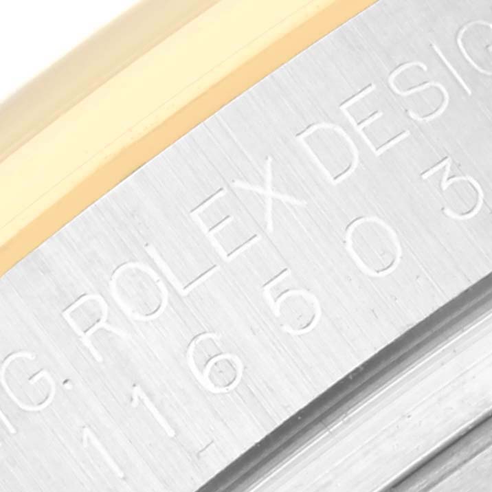 The image shows a close-up of the engraved case side of a Rolex Daytona 116503 Men
s Steel and Gold (two tone) Black Dial 116503 Men
s Steel and Gold (two tone) Black Dial watch, displaying its serial number.