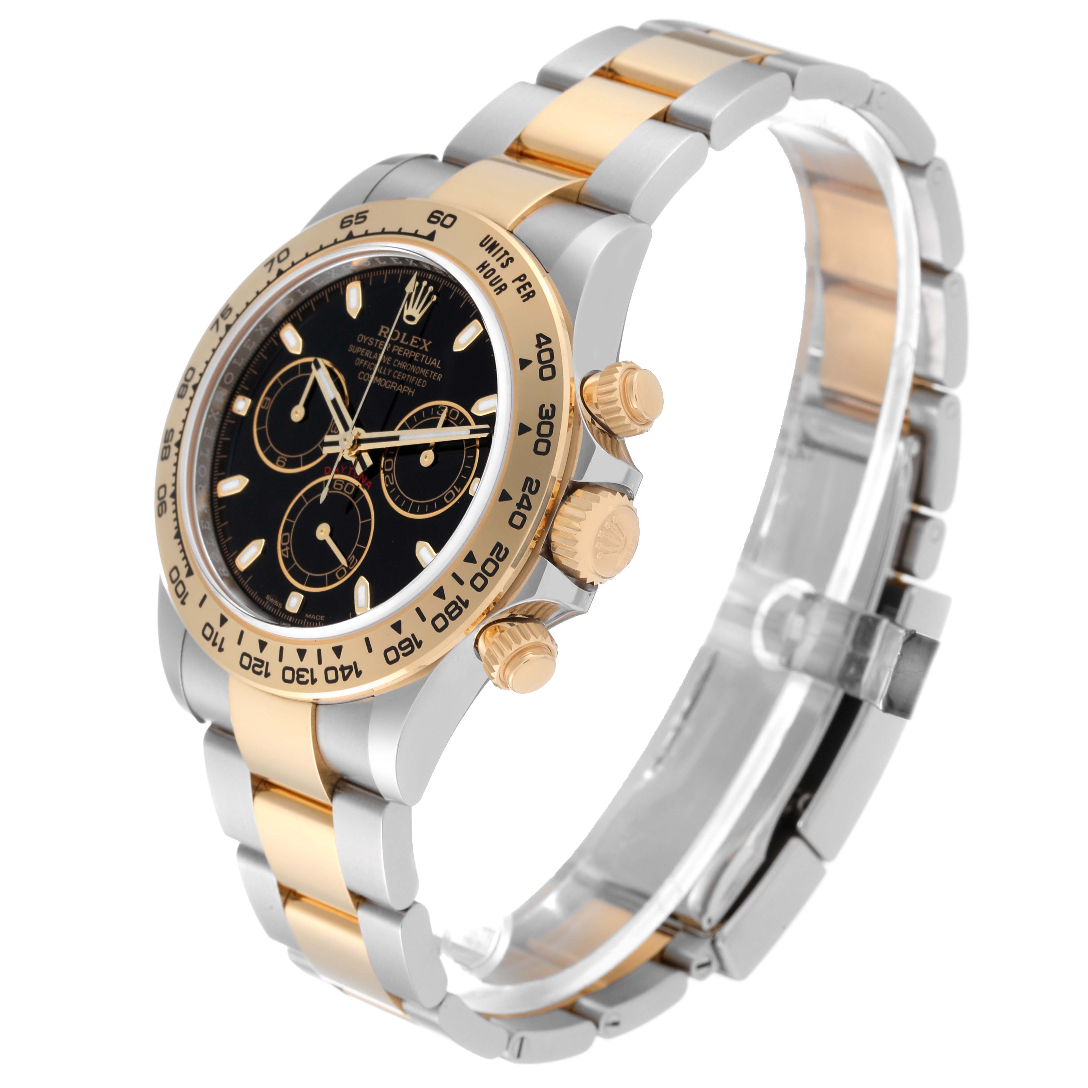 The image shows a side angle of a Rolex Daytona 116503 Men
s Steel and Gold (two tone) Black Dial 116503 Men
s Steel and Gold (two tone) Black Dial, displaying the watch face, bezel, buttons, and part of the bracelet.