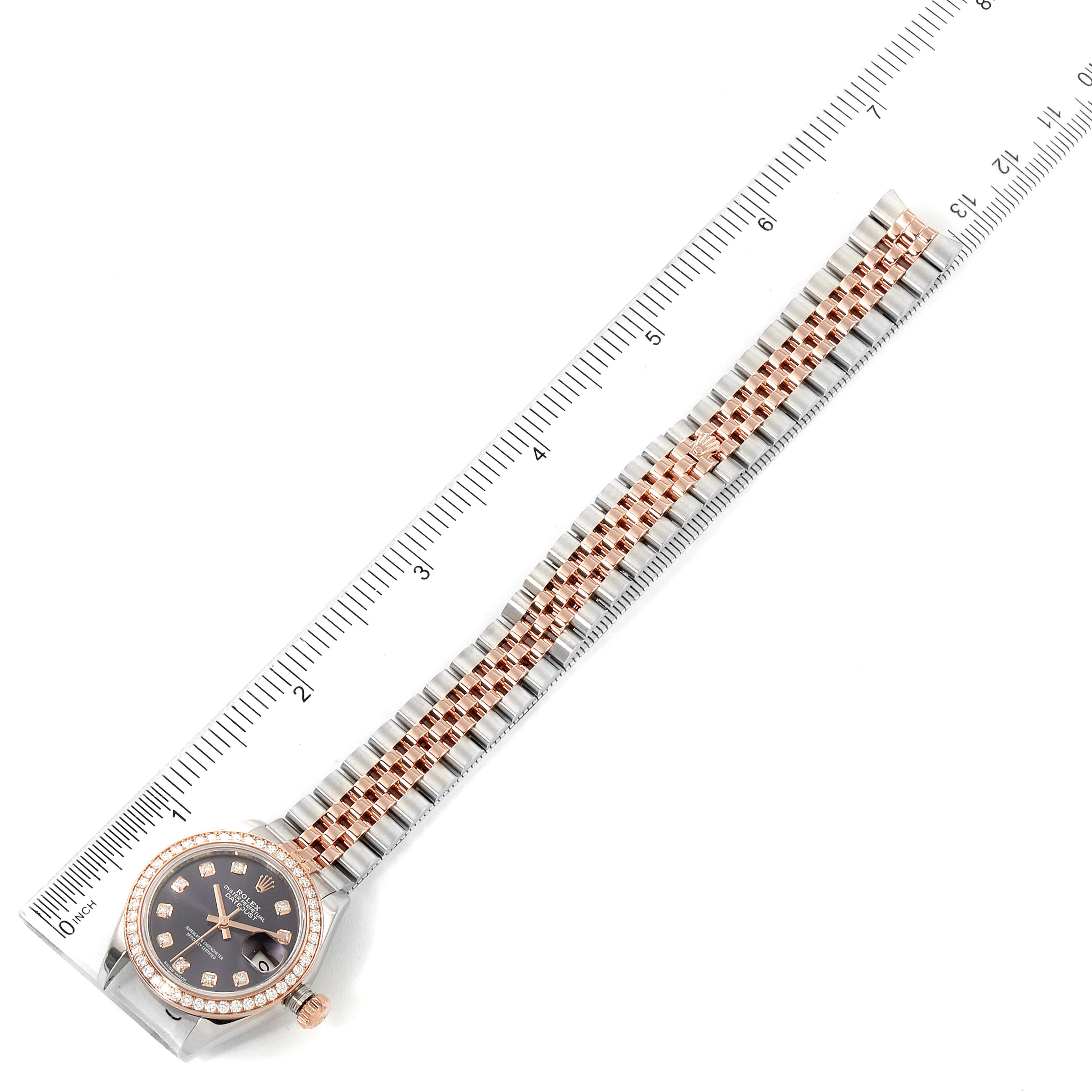 This image shows a Rolex Datejust 279381 Women's Steel and Gold (two tone) Blue Dial 279381 Women's Steel and Gold (two tone) Blue Dial watch and its bracelet laid flat next to a ruler, displaying its length.
