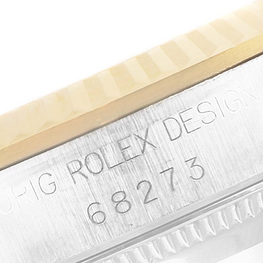 This close-up image shows the engraved side of a Mid-Size Rolex watch with model number 68273.