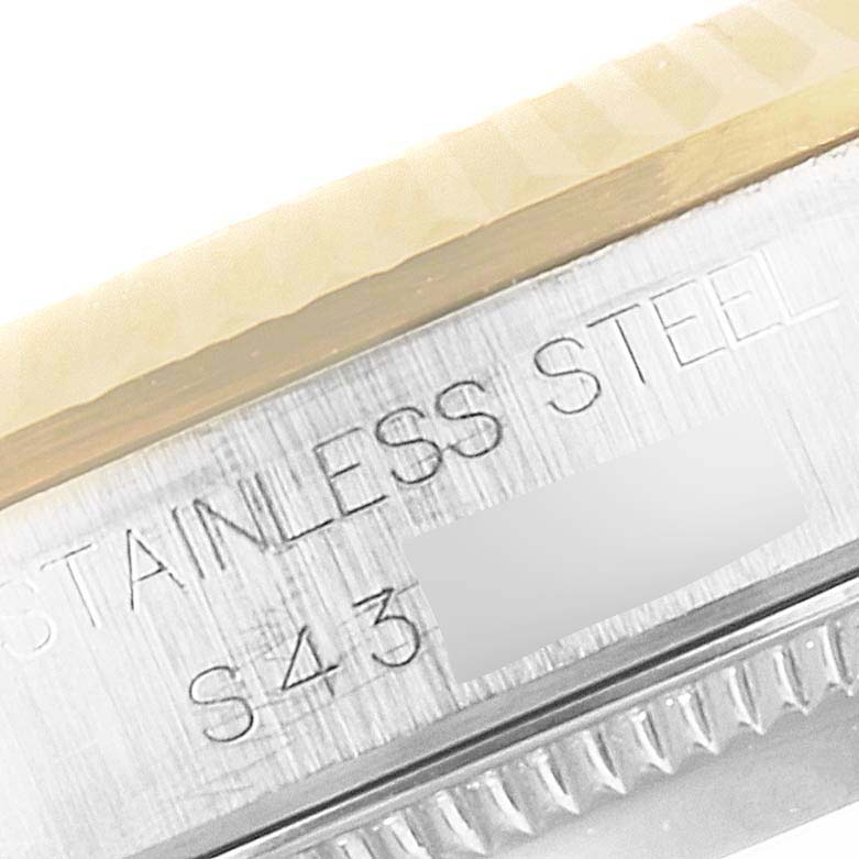 The image shows a close-up of the stainless steel case and bezel of a Rolex Mid-Size 68273 Women
s Steel and Gold (two tone) White Dial 68273 Women
s Steel and Gold (two tone) White Dial watch.