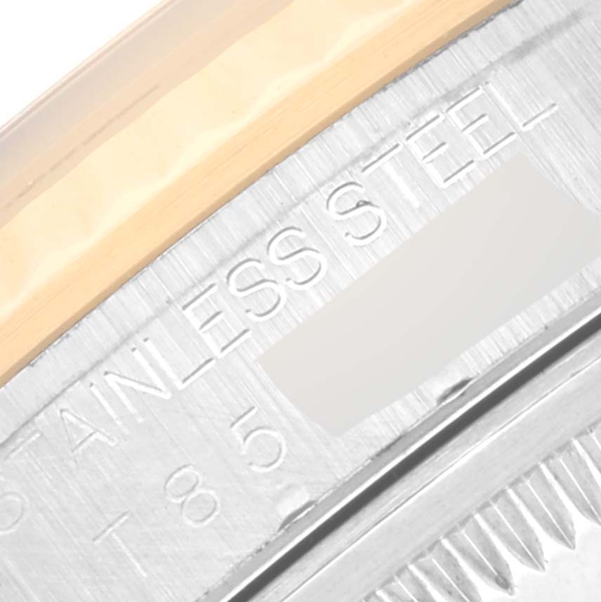 This image shows a close-up angle of the stainless steel and gold bezel of the Rolex Datejust 16233 Men's Steel and Gold (two tone) Black Dial 16233 Men's Steel and Gold (two tone) Black Dial watch.